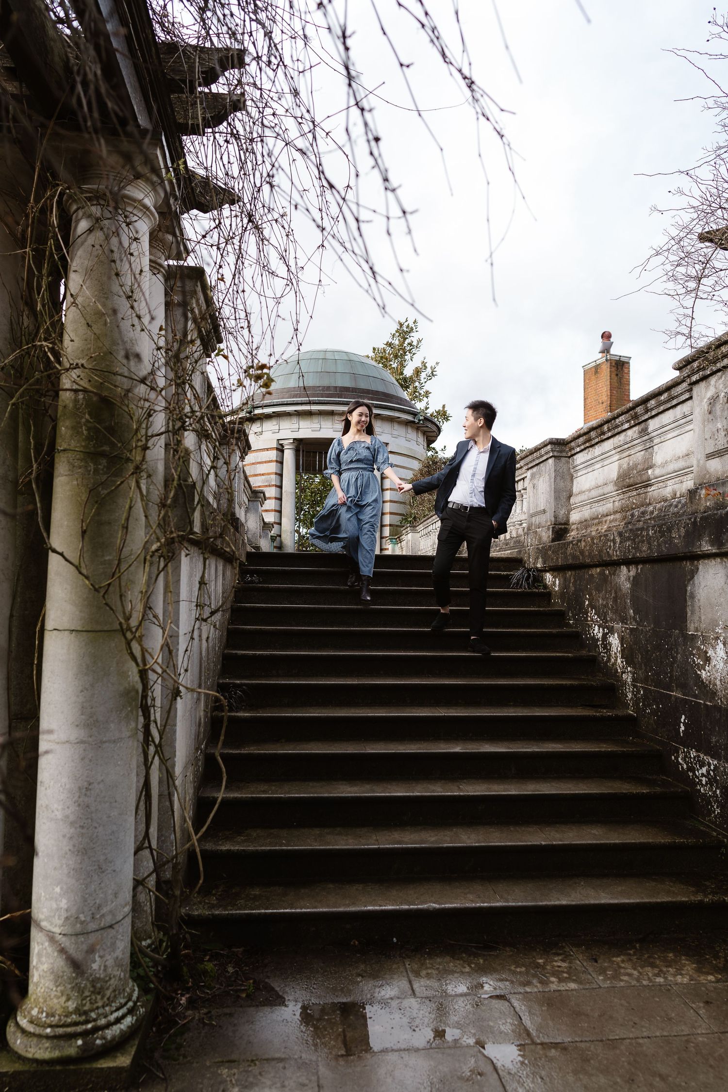 A helping hand to guide his bride to be down the stairs, Hampstead heath, London destination photographer