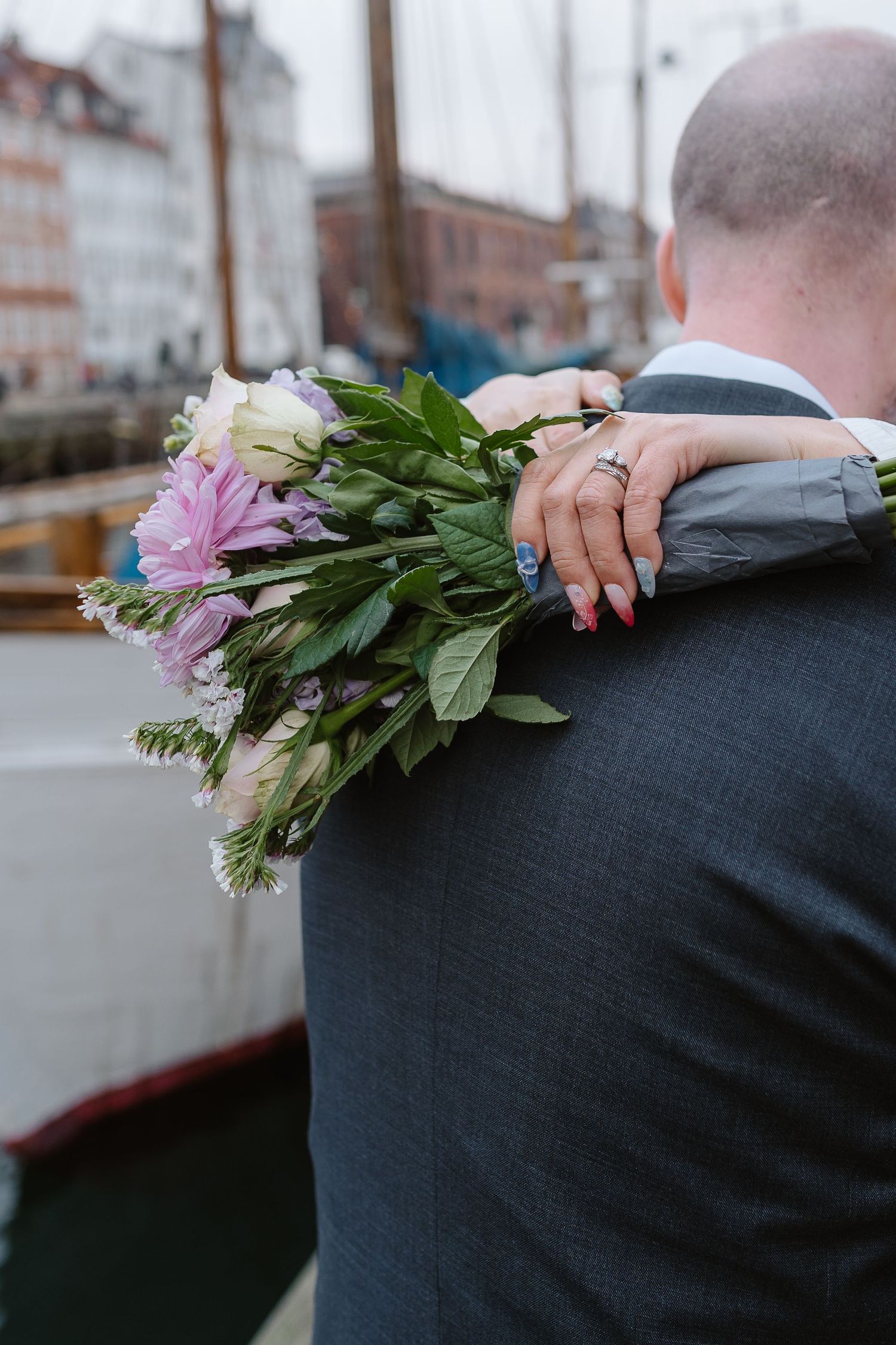Newlyweds bouquet along Nyhavn Canal in Copenhagen. Denmark wedding. Scandinavian & Destination Wedding Photographer