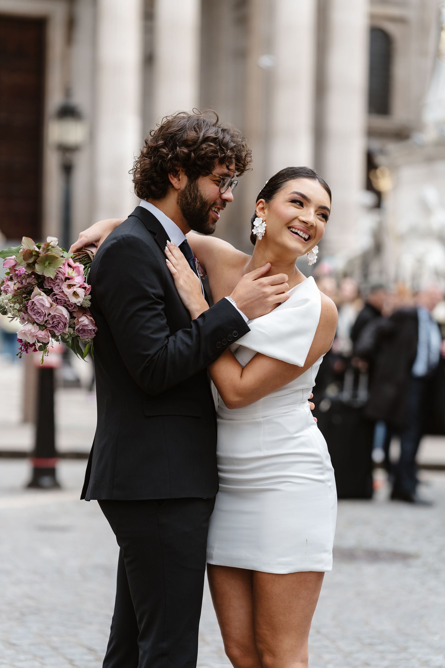 Luxury Bride & Groom walking past St Paul's Cathedral in London on wedding elopement. Wedding photographer