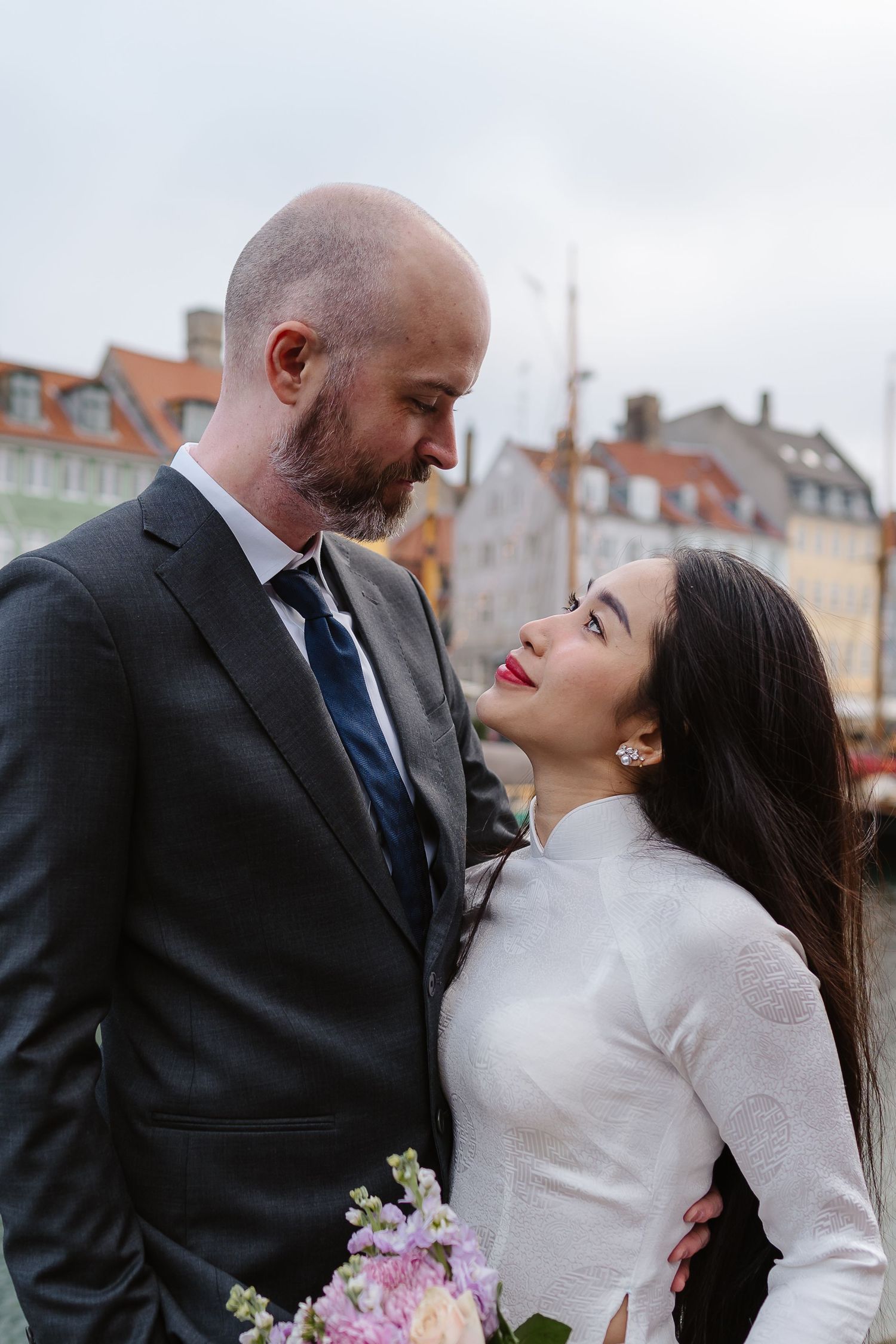 Newlyweds romantic along Nyhavn Canal in Copenhagen. Denmark wedding. Scandinavian & Destination Wedding Photographer