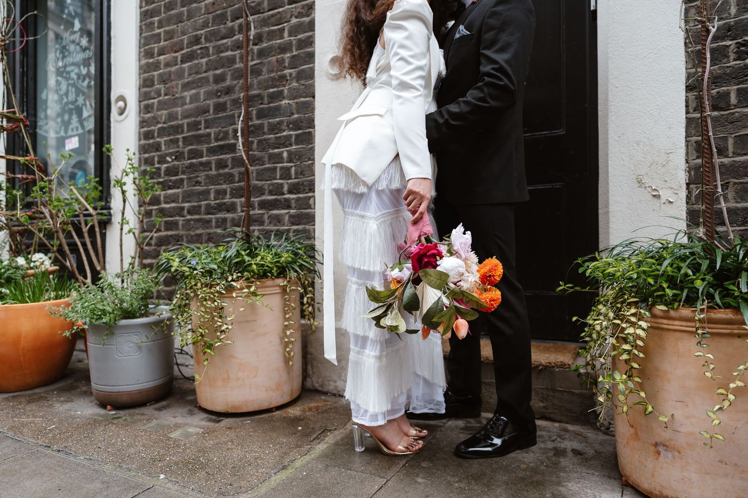 Relaxed wedding couple at The Hoxton, Holborn. London Wedding Photographer.  vibrant bouquet flowers