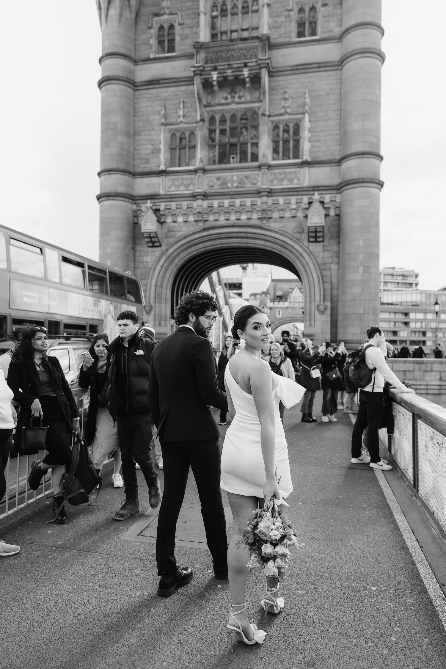 Luxury wedding photos at Tower Bridge. Bride short dress. Fun photos. Editorial. London Wedding Photographer. romantic