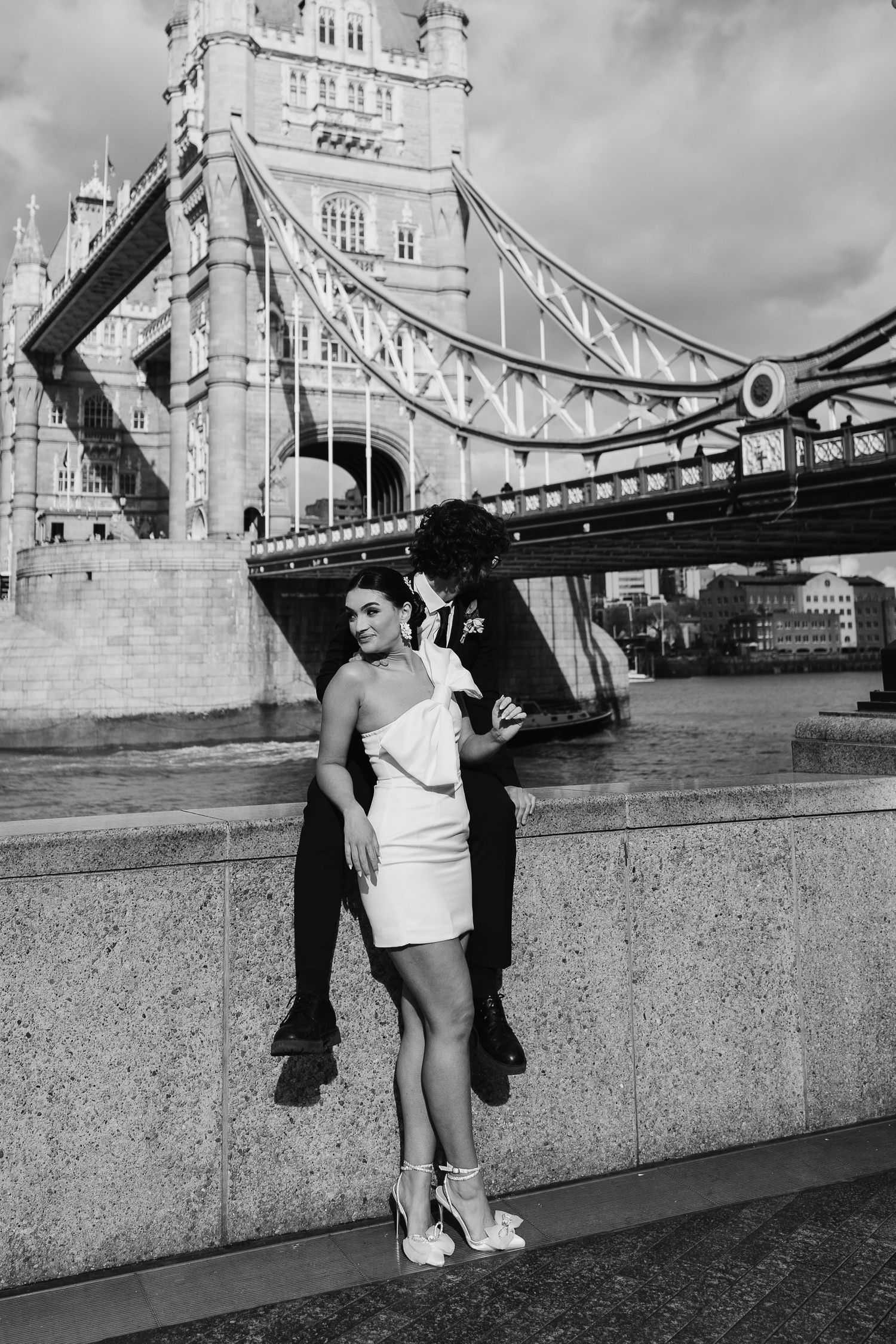 Luxury wedding photos at Tower Bridge. Bride short dress. Fun photos. Editorial. London Wedding Photographer