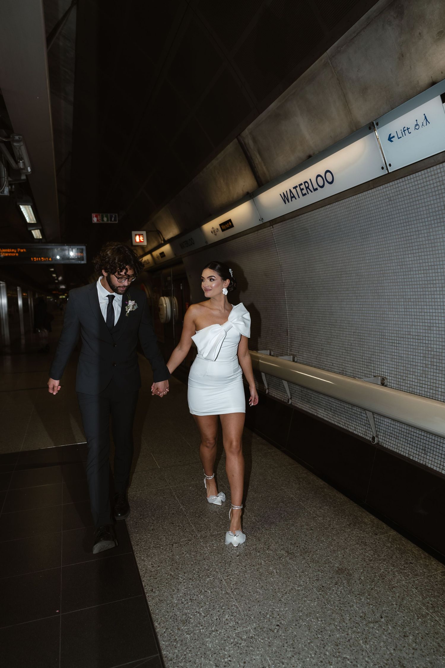bride and groom in the London Underground Tube, direct flash editorial photography. Modern fun wedding photos. London