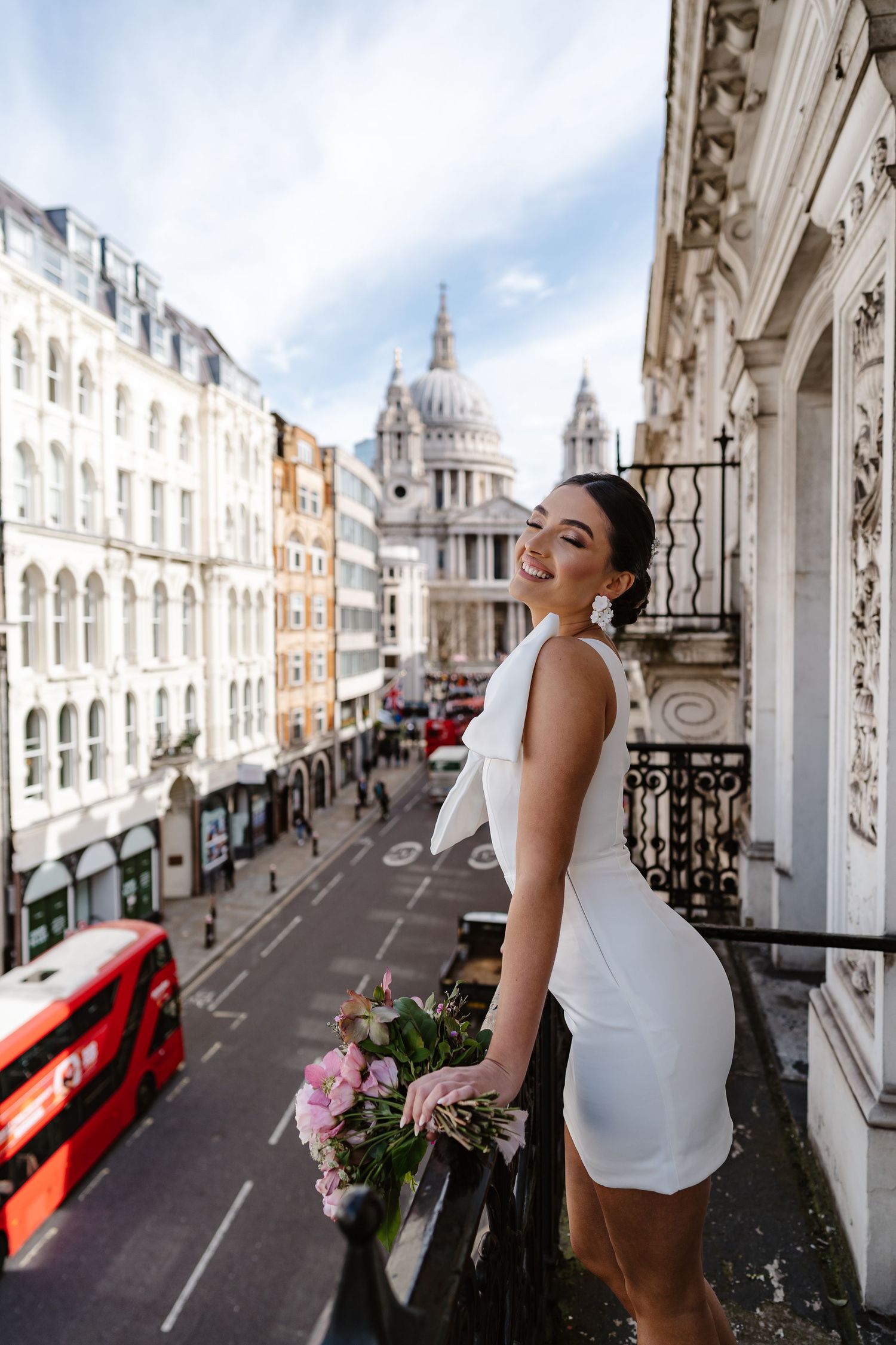 Luxury Bride on Parisian-style balcony overlooking St Paul's Cathedral in London for his wedding elopement.