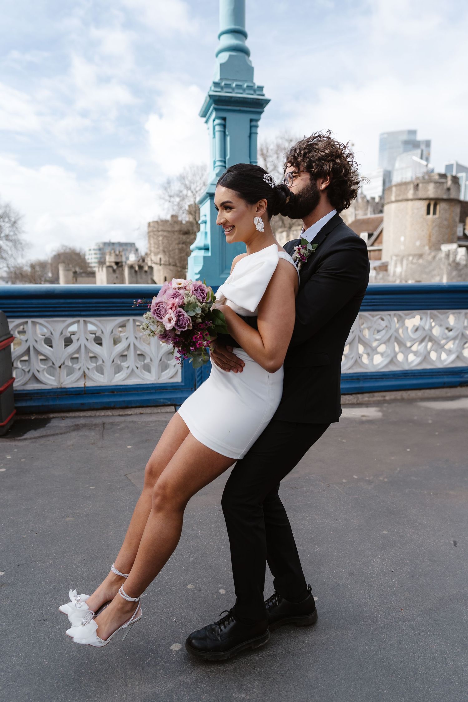 Luxury wedding photos at Tower Bridge. Bride short dress. Fun photos. Editorial. London Wedding Photographer. romantic