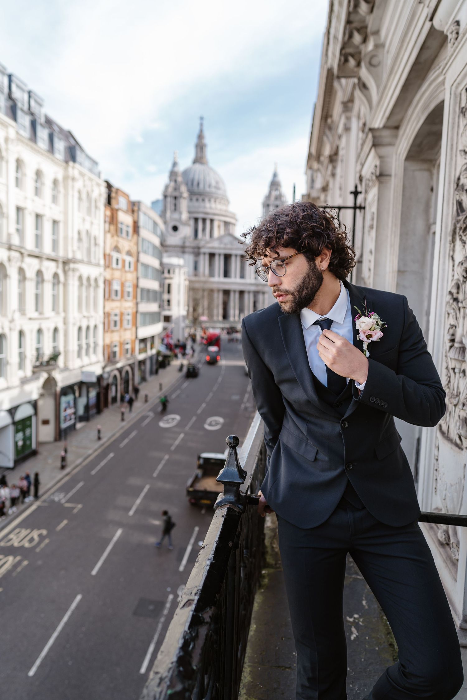 Groom on Parisian-style balcony overlooking St Paul's Cathedral in London for his wedding elopement.