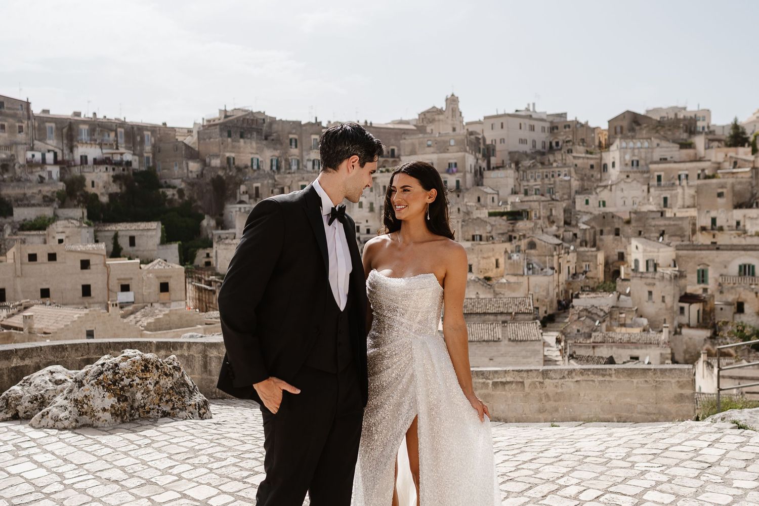 Romantic/intimate tender moment loving look, old town backdrop