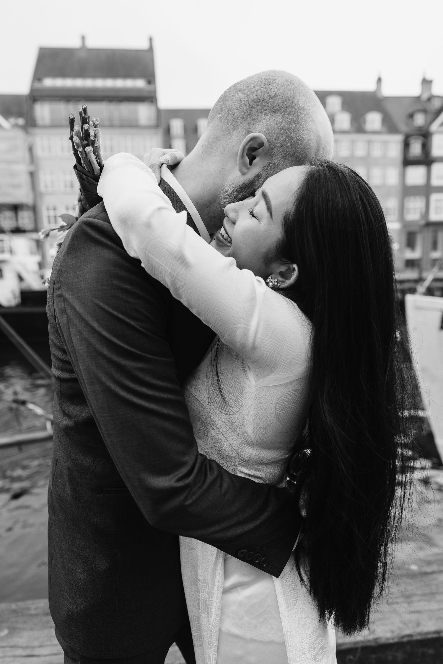 Newlyweds walking along Nyhavn Canal in Copenhagen. Denmark wedding. Scandinavian & Destination Wedding Photographer