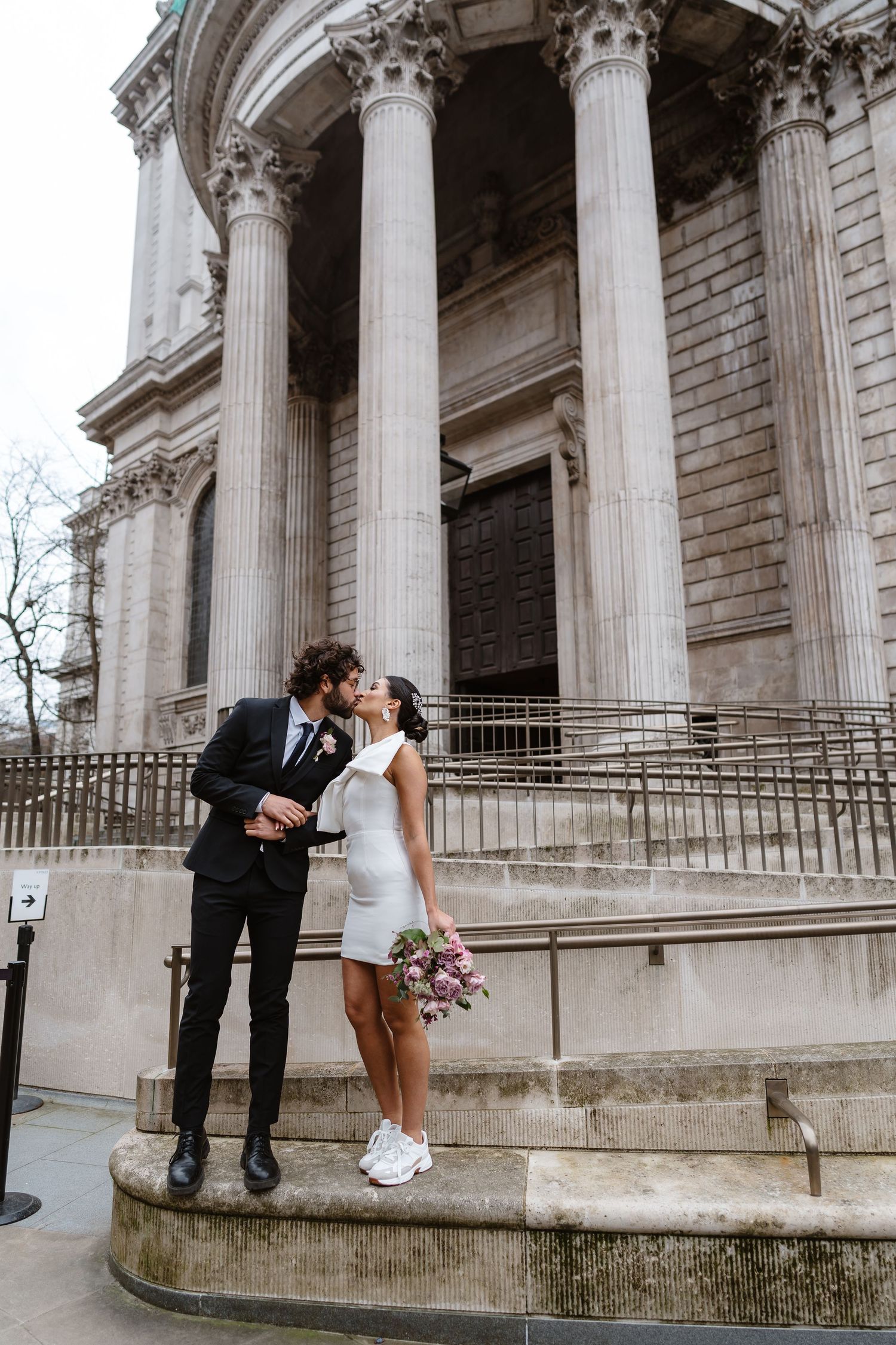 Luxury Bride & Groom walking past St Paul's Cathedral in London on wedding elopement. Wedding photographer