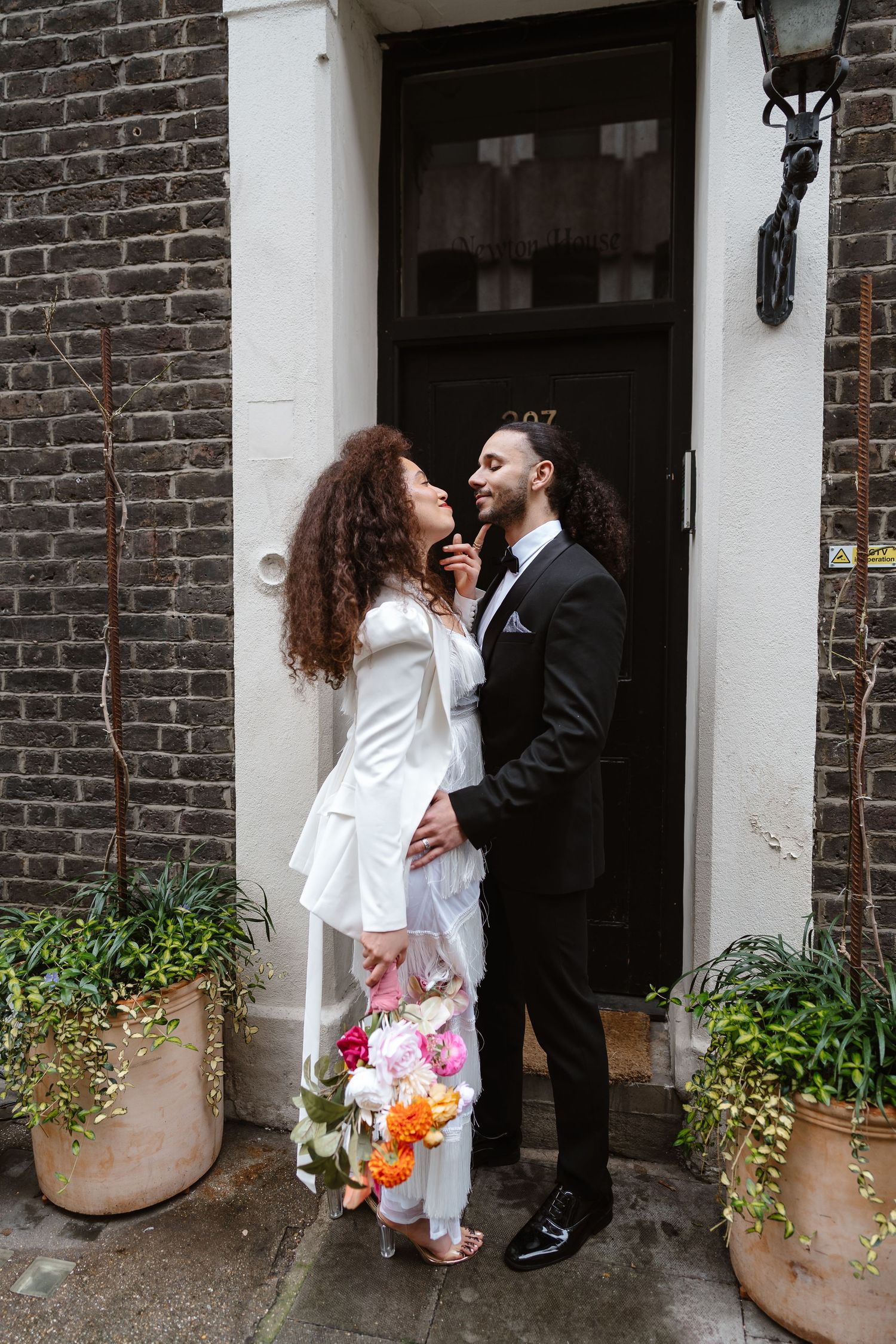 Relaxed wedding couple at The Hoxton, Holborn. London Wedding Photographer.  vibrant bouquet flowers