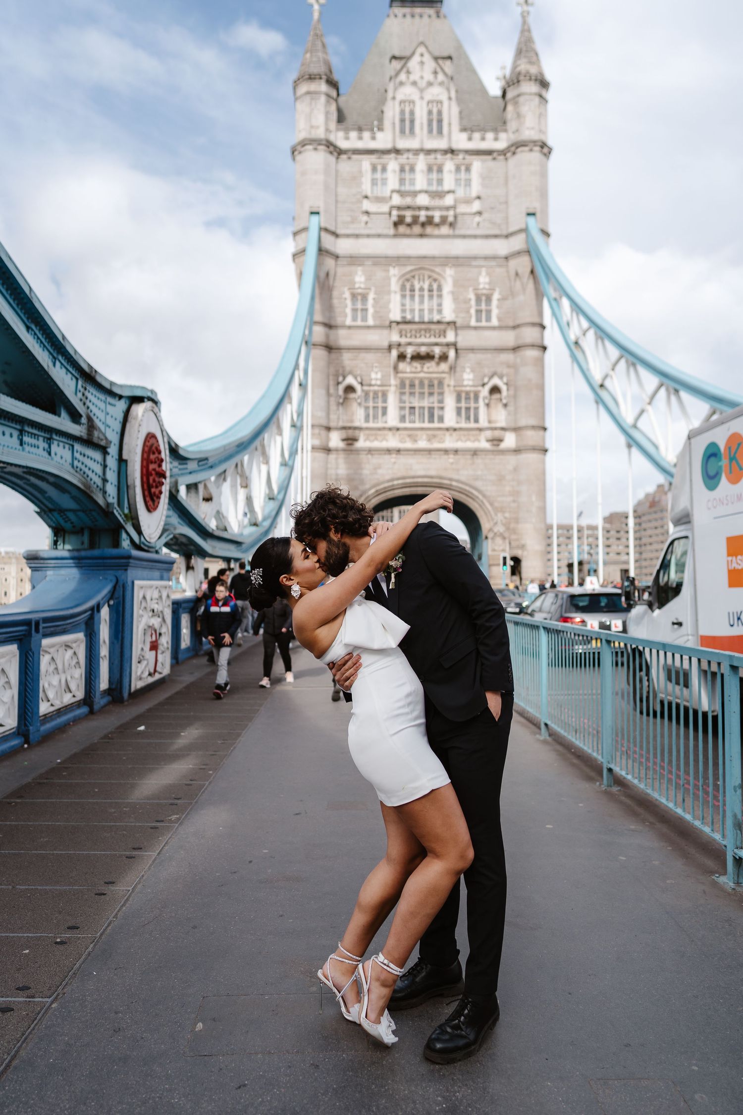 Luxury wedding photos at Tower Bridge. Bride short dress. elegant. Editorial. London Wedding Photographer. romantic