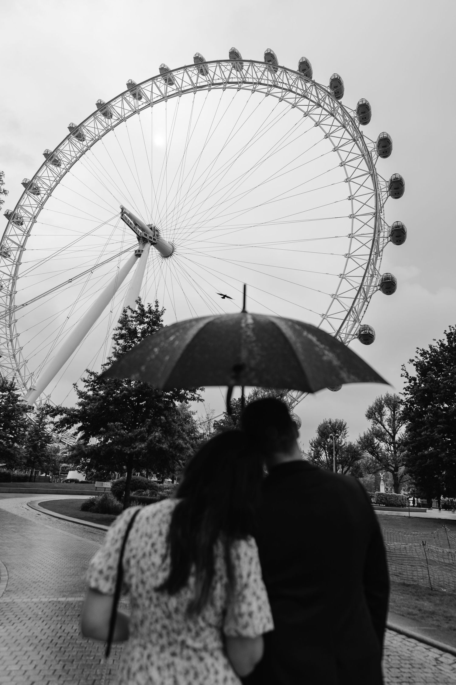 Warming embrace under the umbrella admiring  the view of the London eye