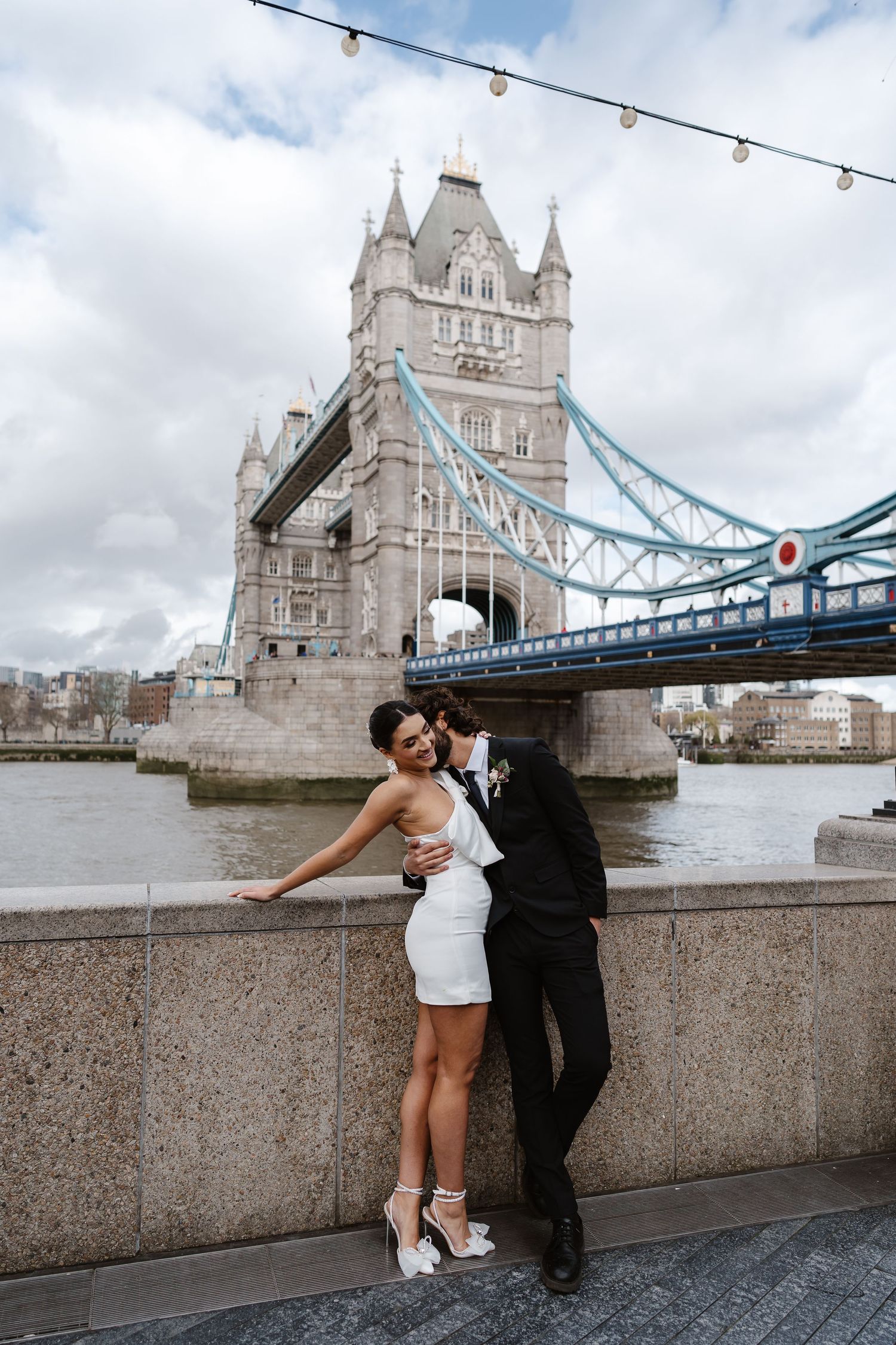 Luxury wedding photos at Tower Bridge. Bride short dress. Fun photos. Editorial. London Wedding Photographer