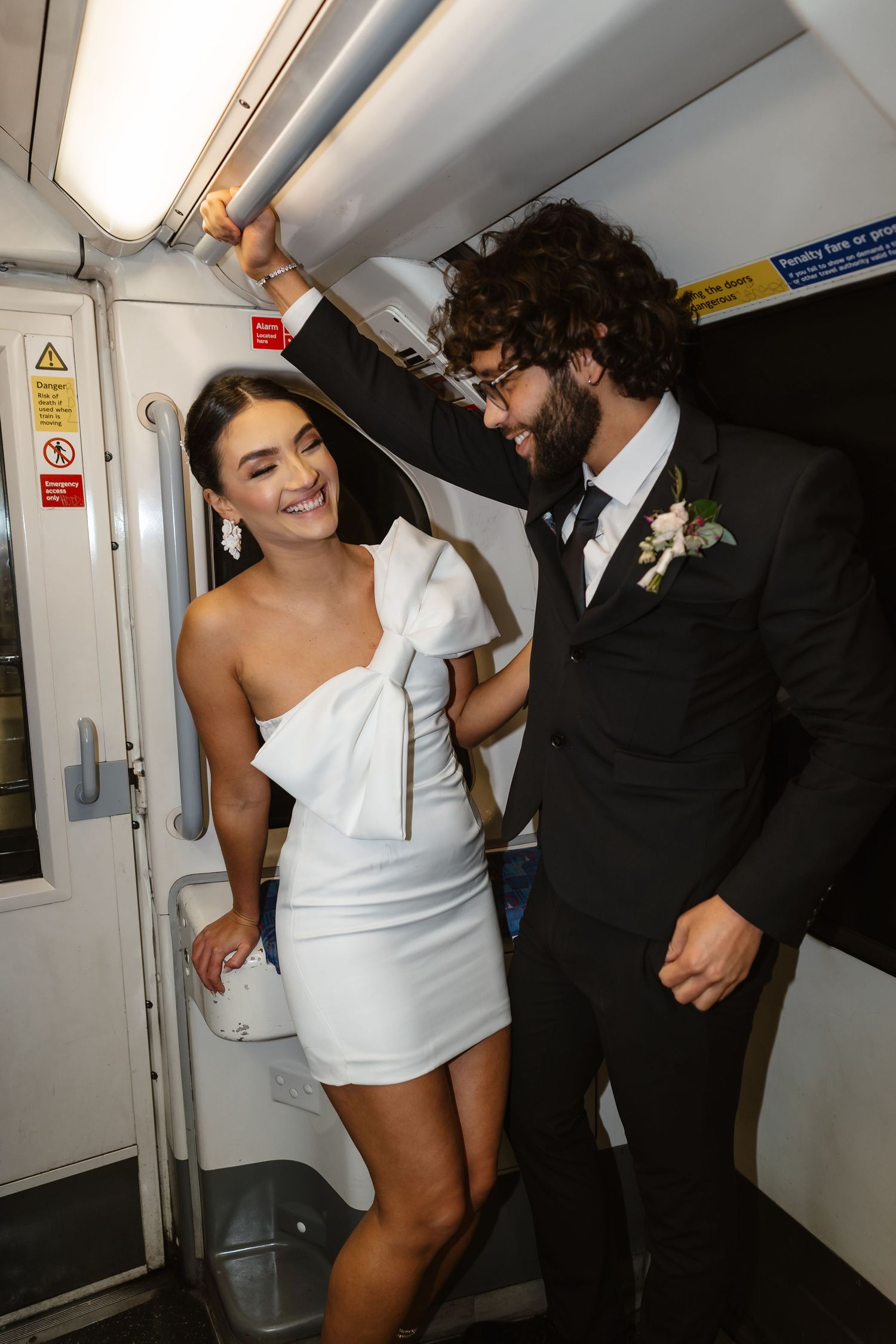 bride and groom in the London Underground Tube, direct flash editorial photography. Modern fun wedding photos. London