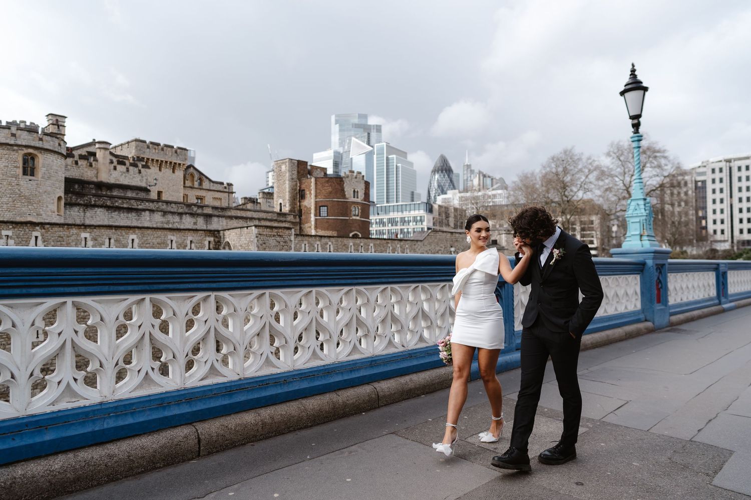 Luxury wedding photos at Tower Bridge. Bride short dress. Fun photos. Editorial. London Wedding Photographer