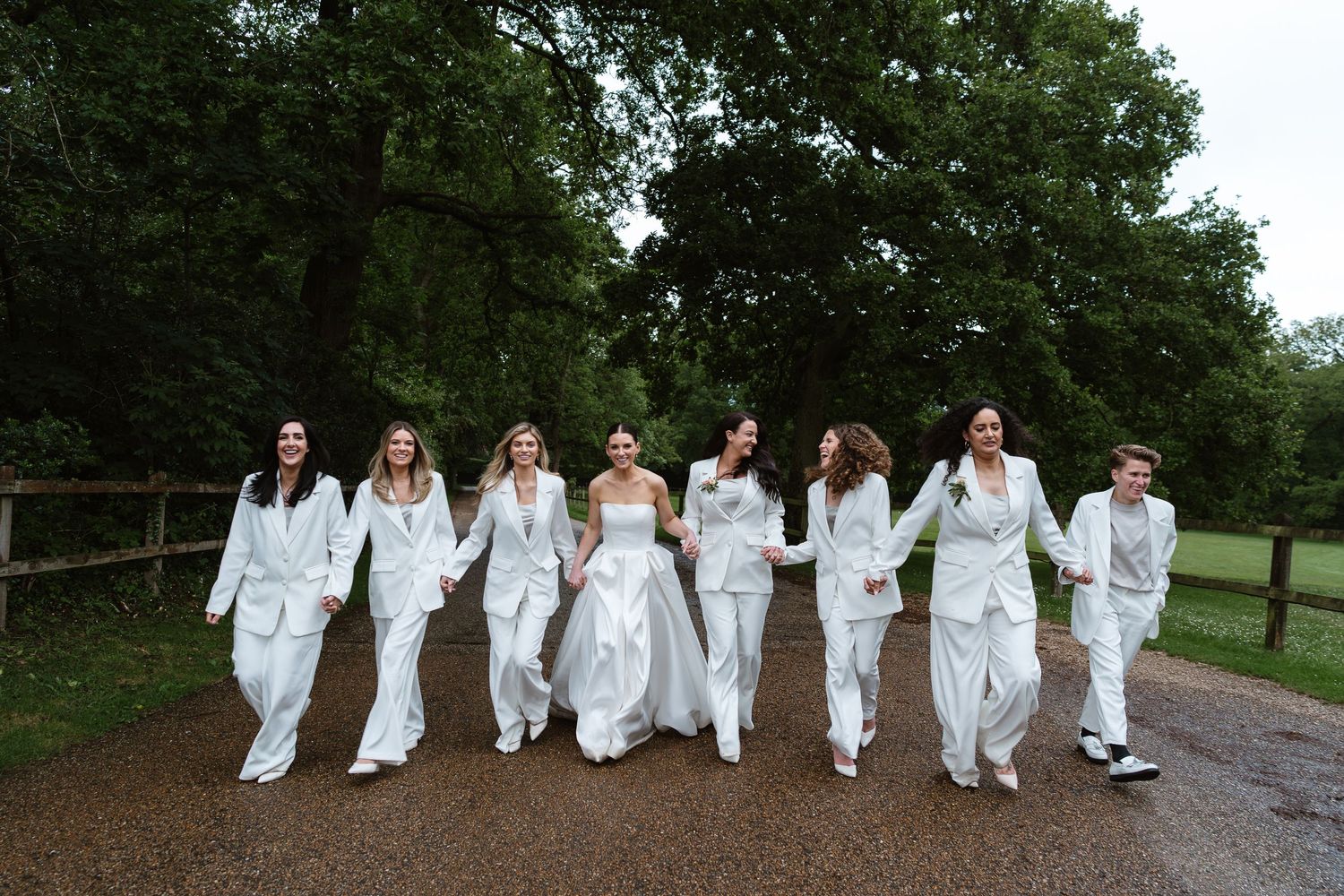 Relaxed & laughing in the rain. Vera Wang dress - White Bridesmaids Suits at Luxury Norfolk Wedding. Bridesmaid inspo