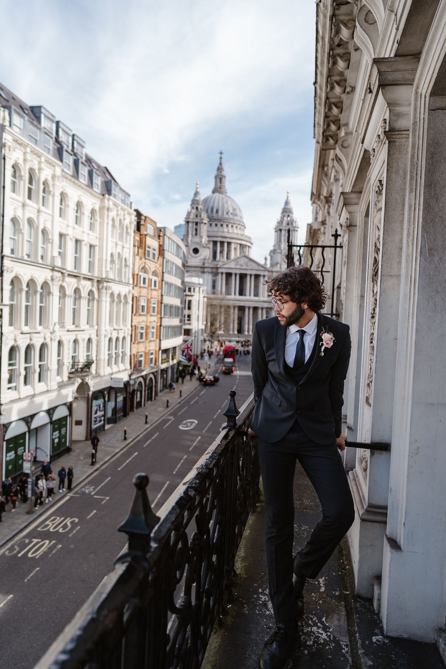 Groom on Parisian-style balcony overlooking St Paul's Cathedral in London for his wedding elopement.