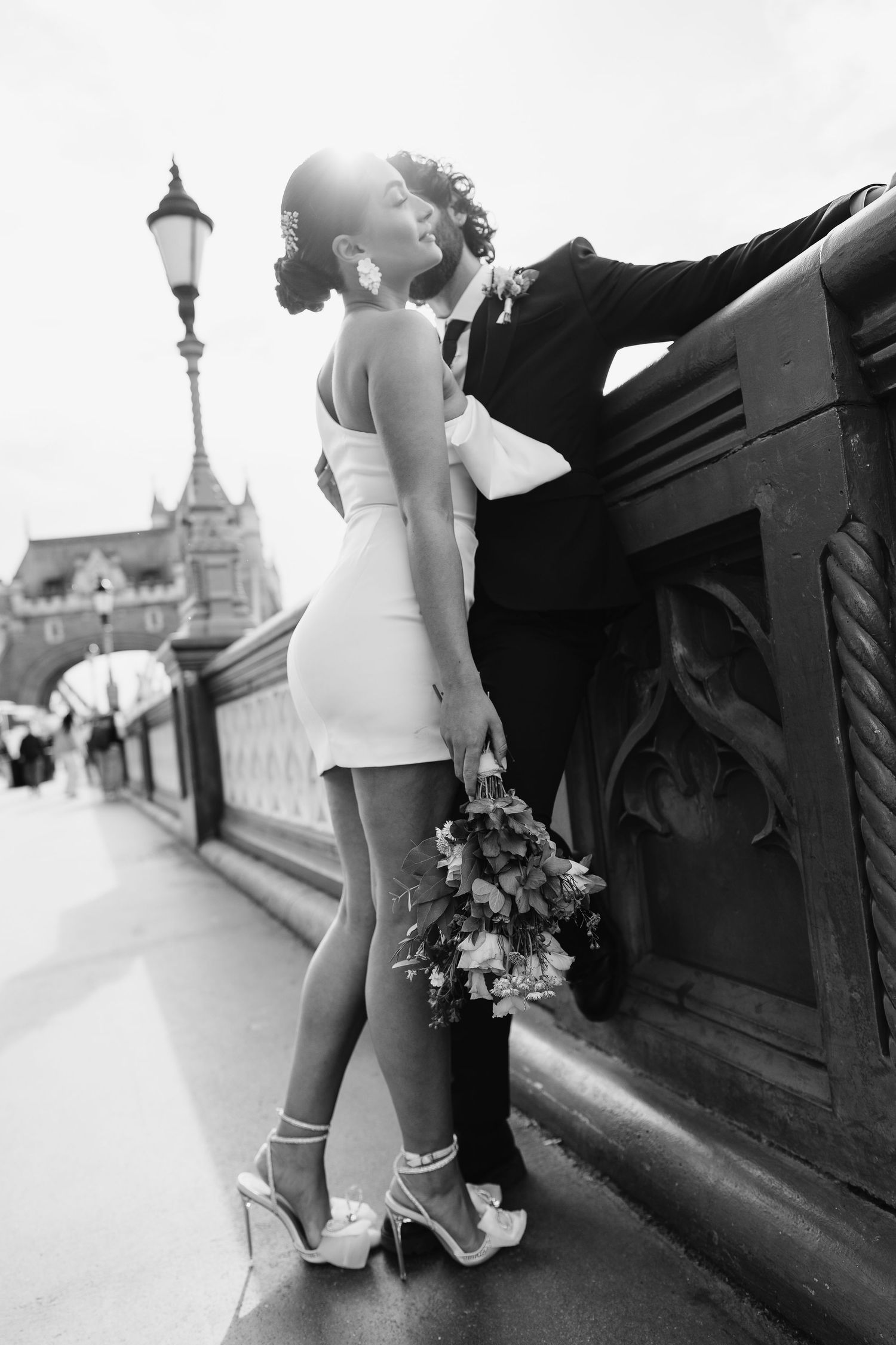 Luxury wedding photos at Tower Bridge. Bride short dress. Fun photos. Editorial. London Wedding Photographer. romantic