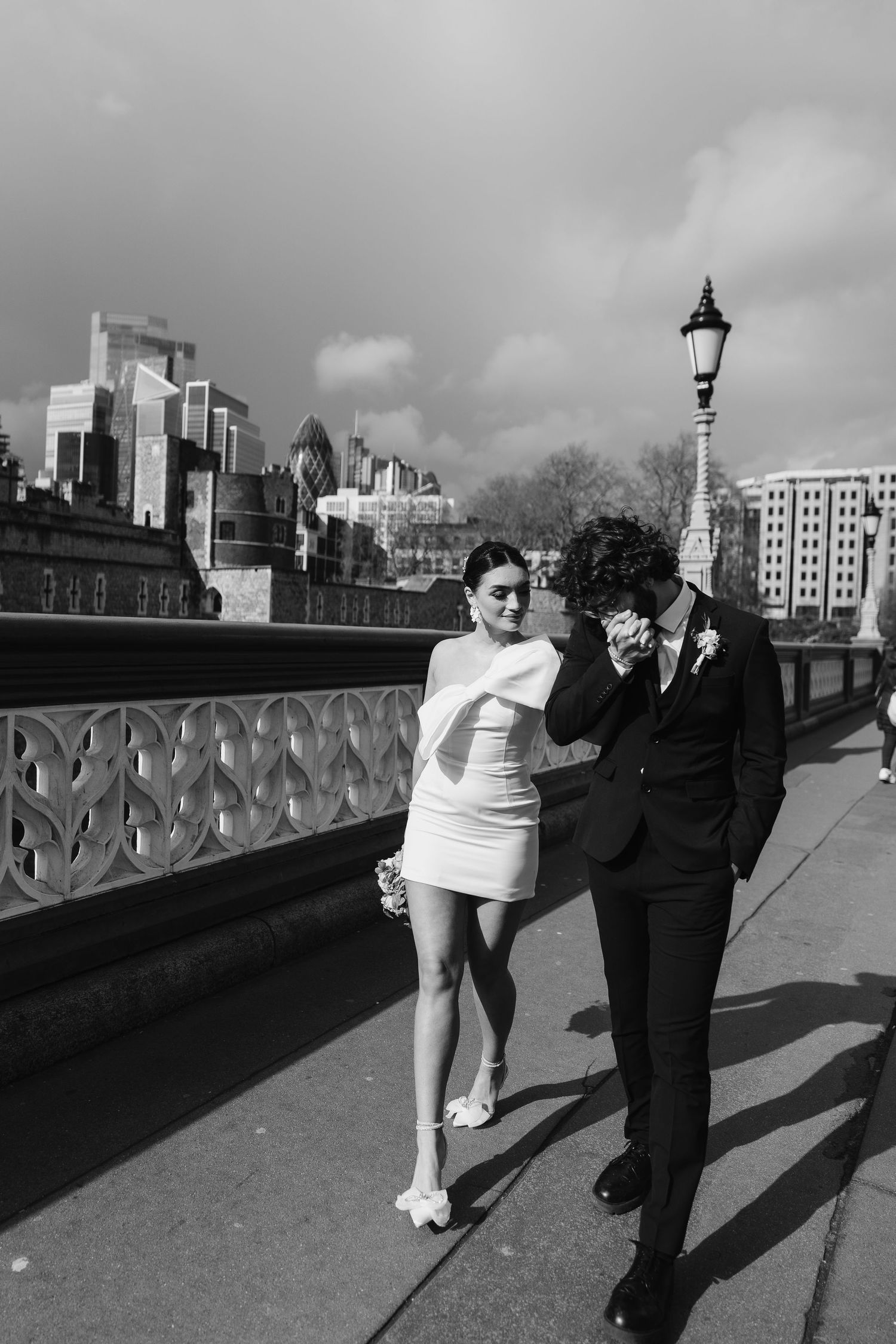 Luxury wedding photos at Tower Bridge. Bride short dress. Fun photos. Editorial. London Wedding Photographer