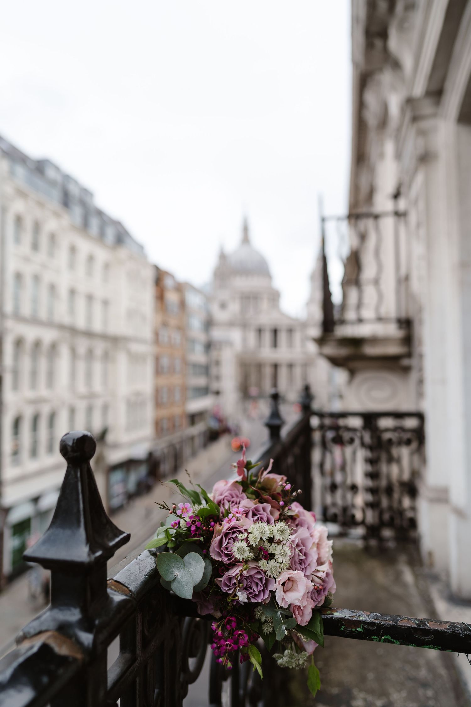 Wedding details. Dusky pink flowers bouquet and bridal shoes. London St Paul's for London Wedding