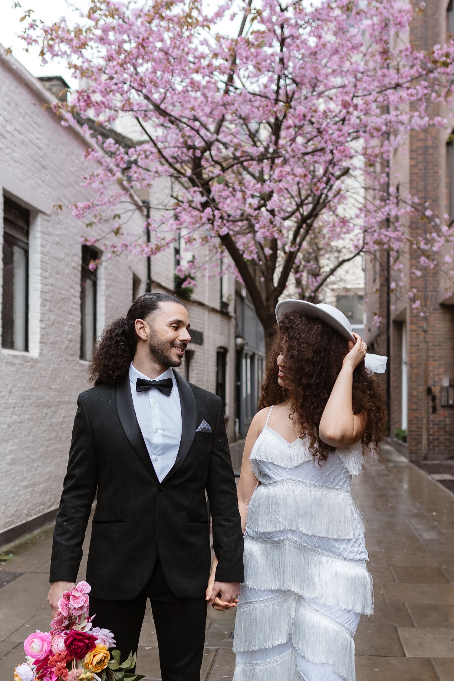 Relaxed wedding couple at The Hoxton, Holborn. London Wedding Photographer.  vibrant bouquet flowers Pink blossom London