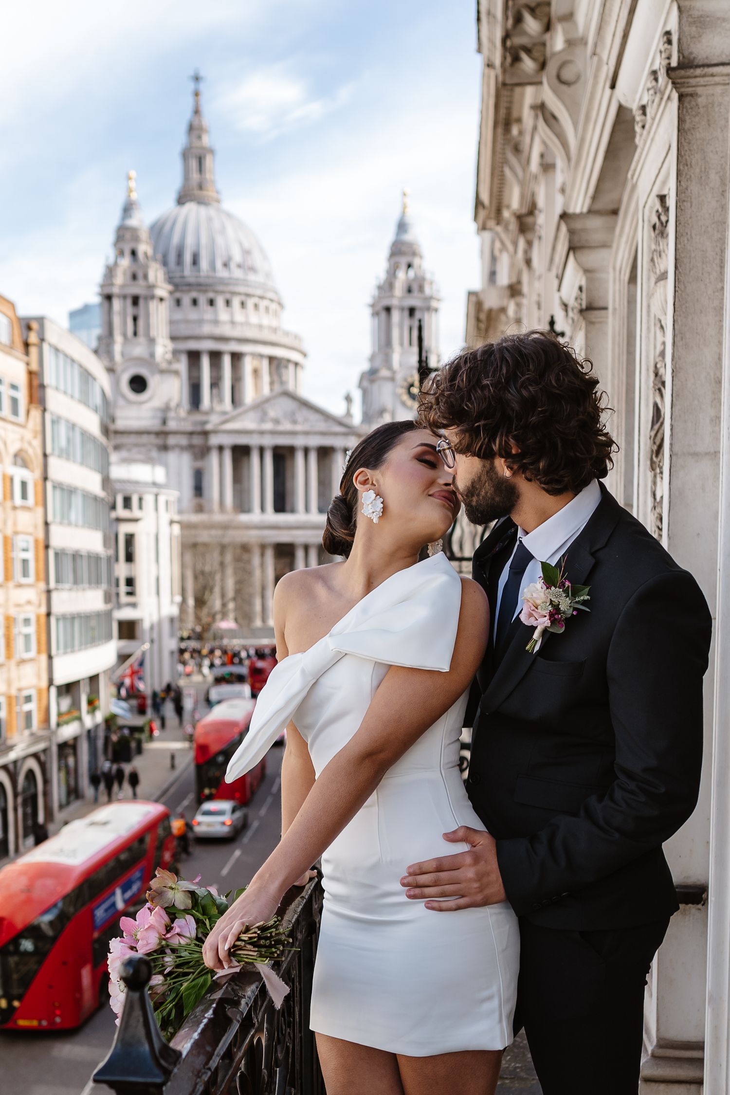 Luxury Bride & Groom on Parisian-style balcony overlooking St Paul's Cathedral in London for his wedding elopement.