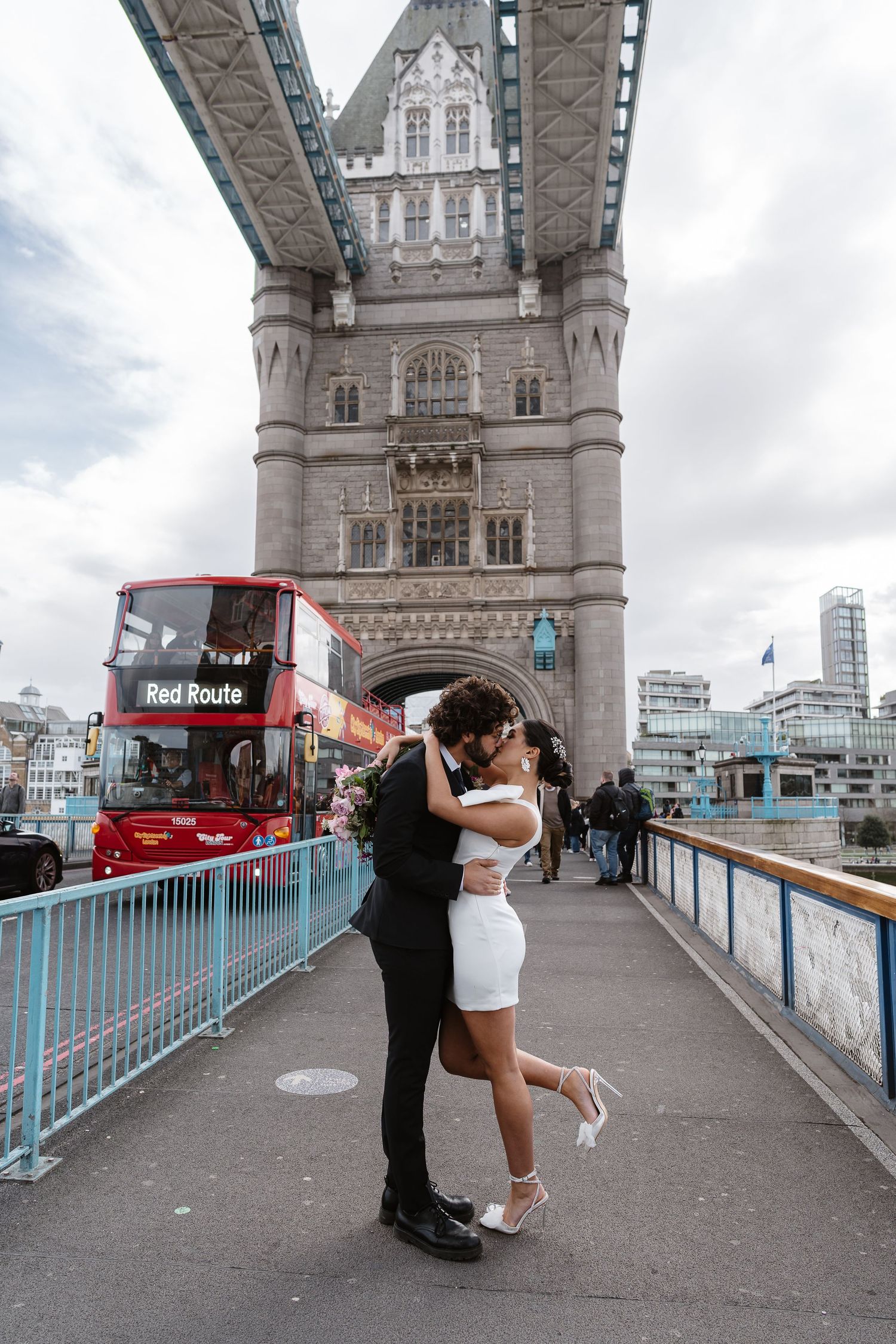 Luxury wedding photos at Tower Bridge. Bride short dress. Fun photos. Editorial. London Wedding Photographer. romantic