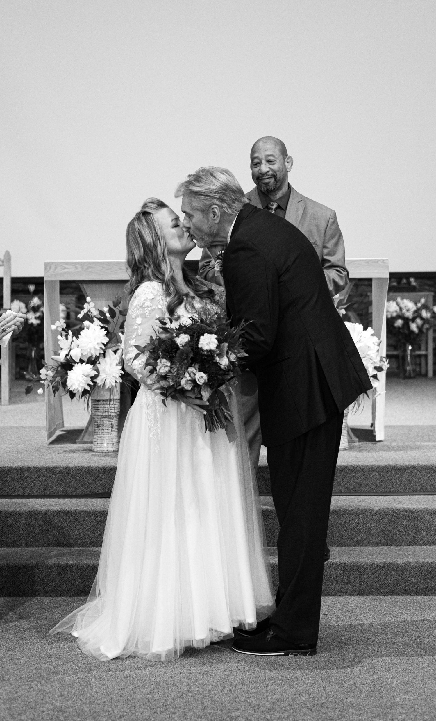 Black and white wedding portraits showing tender moments between a couple on their special day.