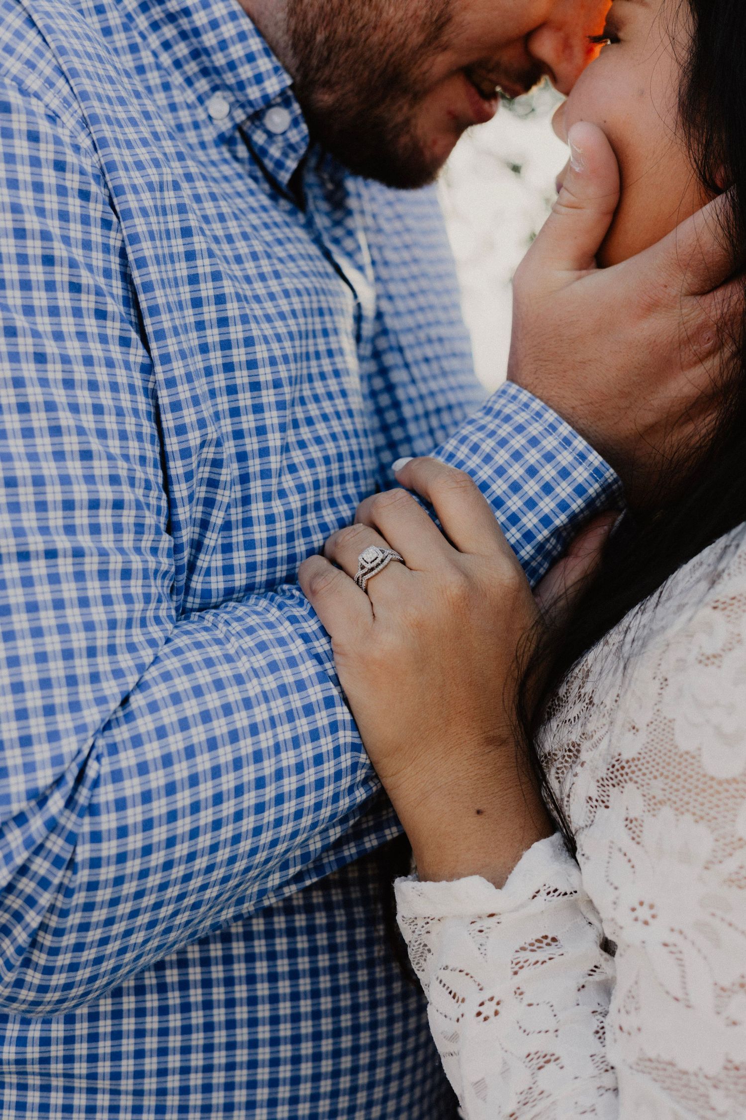 Detail shot of hands and engagement ring during an intimate couples portrait.