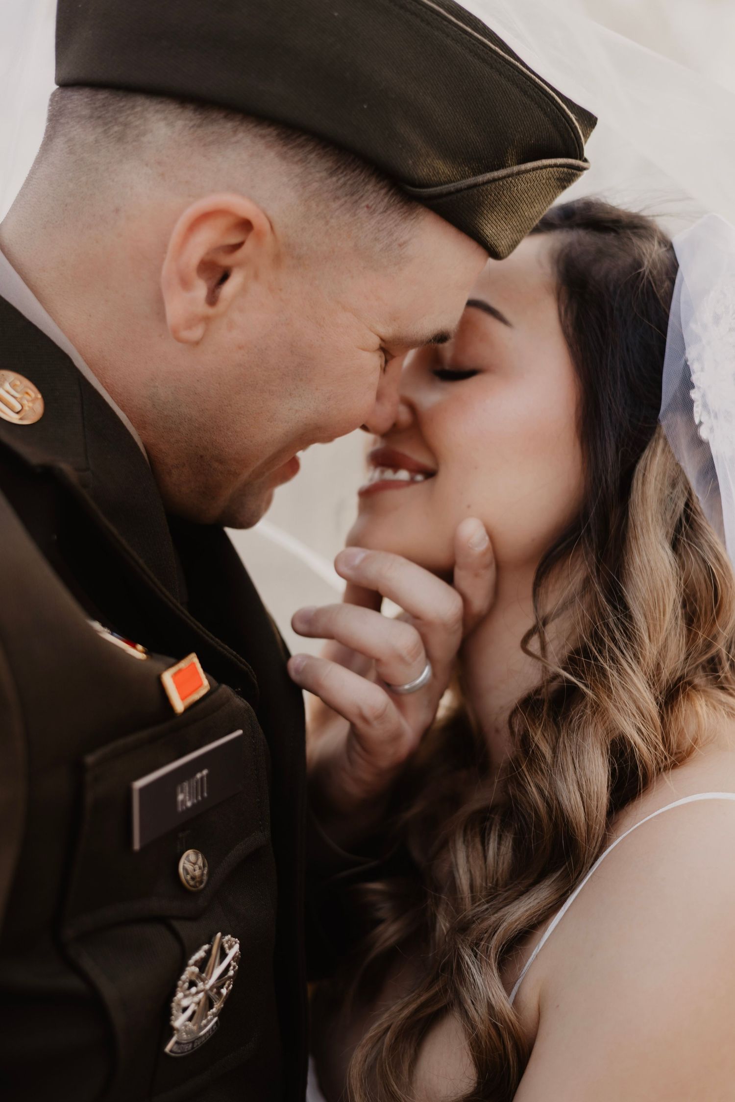 A romantic sequence of wedding day kisses between a couple in close-up shots.
