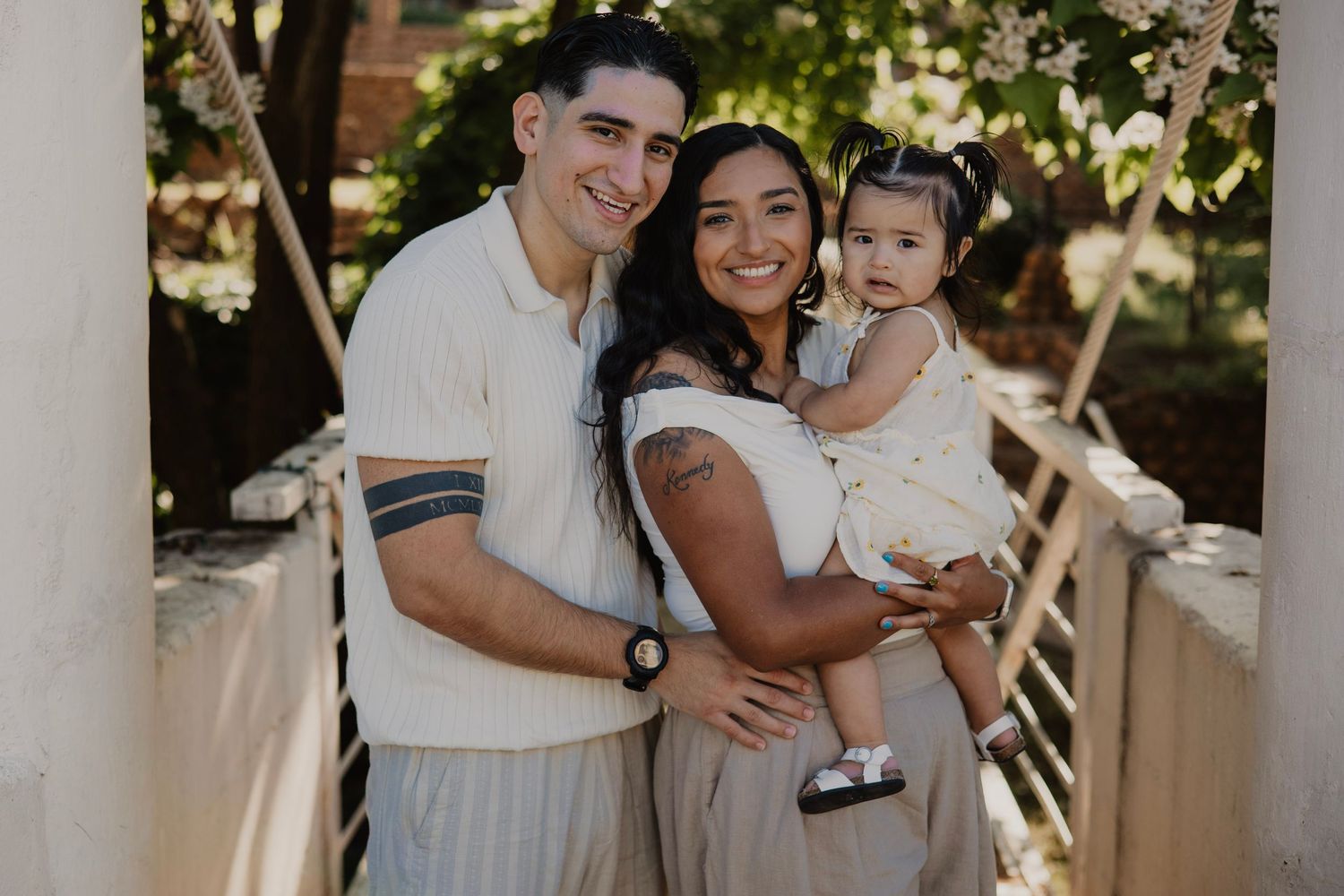 Family embraces and laughs together during outdoor photo session.
