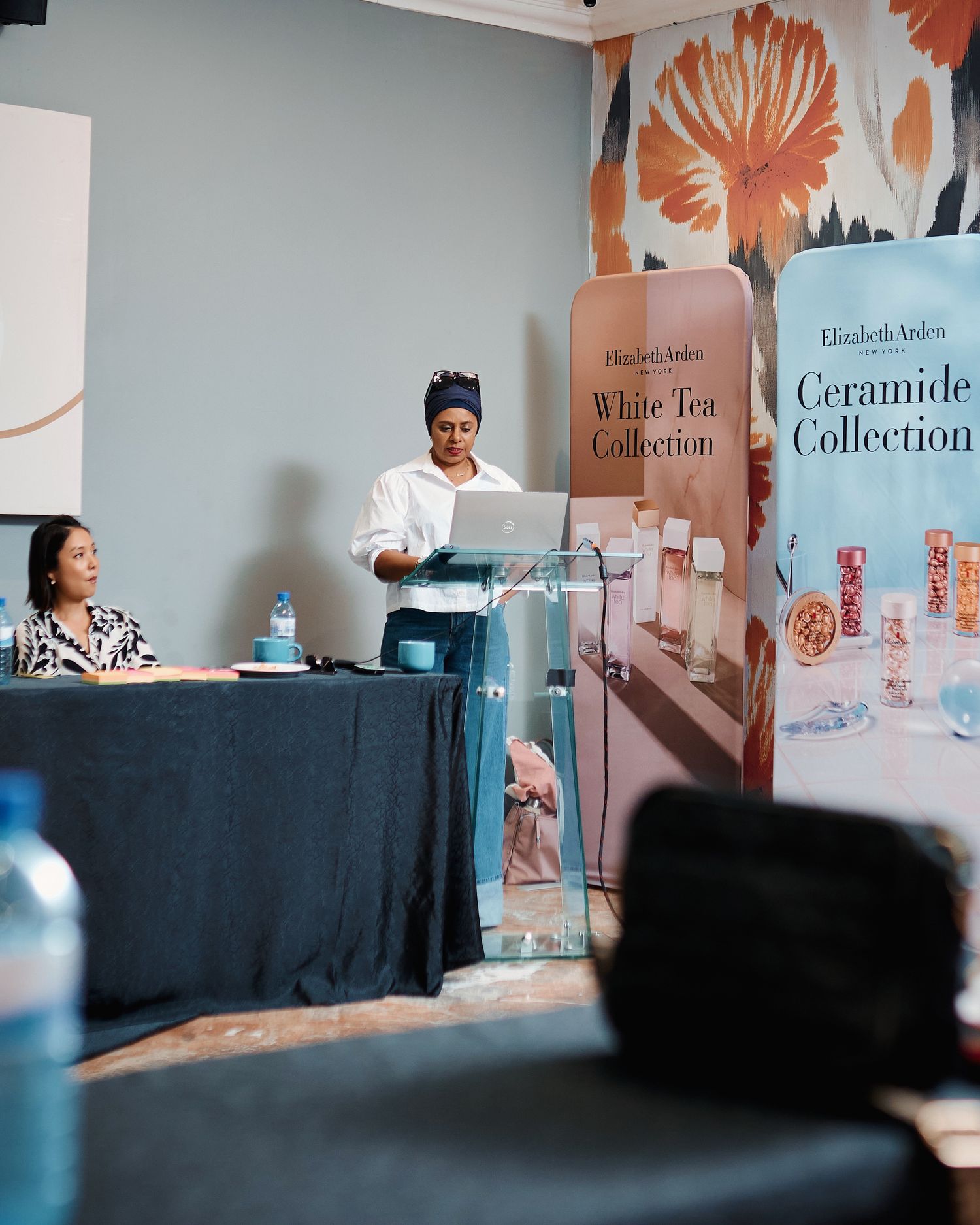 Two women presenting at an Elizabeth Arden White Tea and Ceramide Collection product event.
