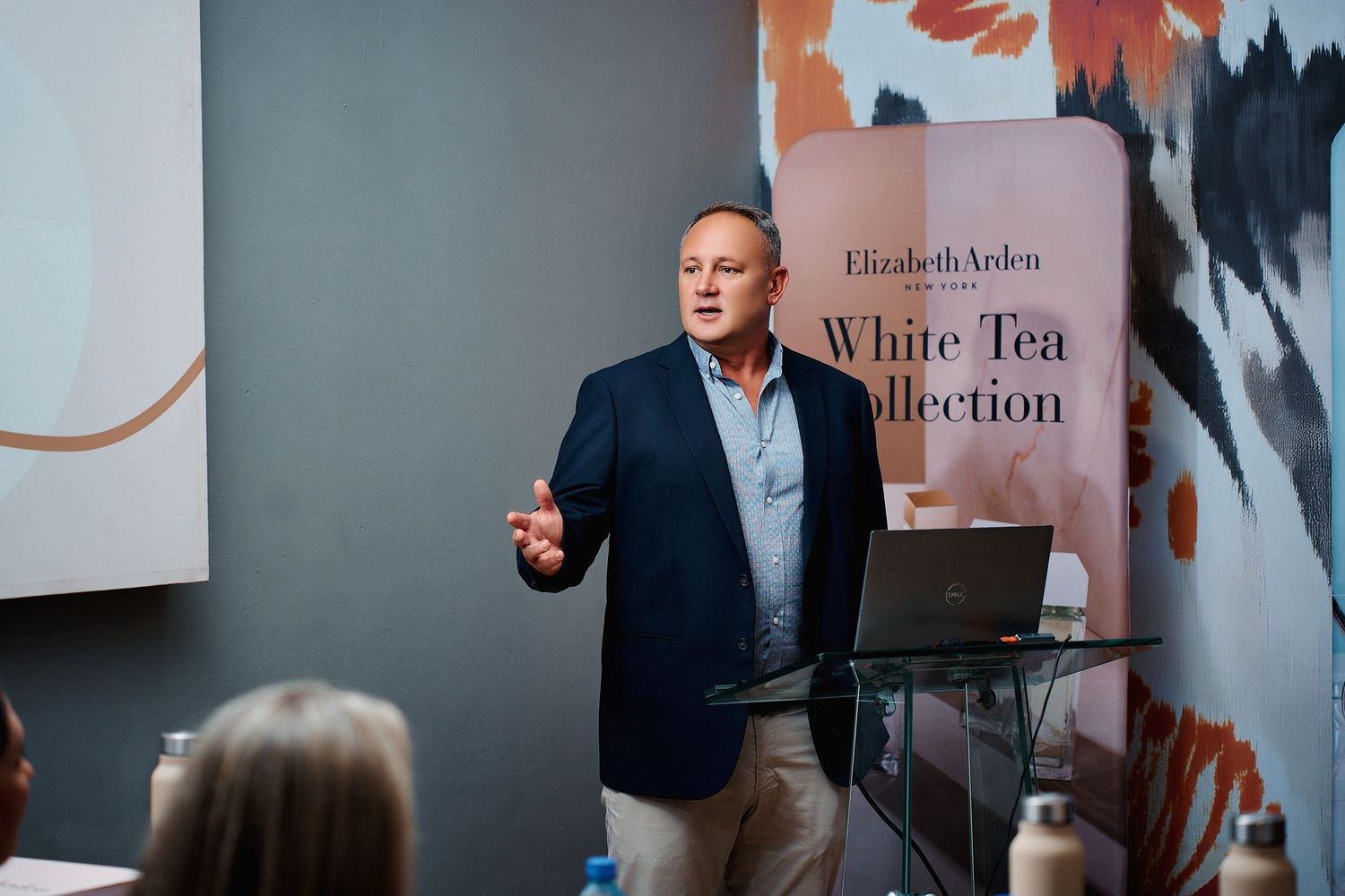 Male presenter speaking at an Elizabeth Arden White Tea Collection product launch event.