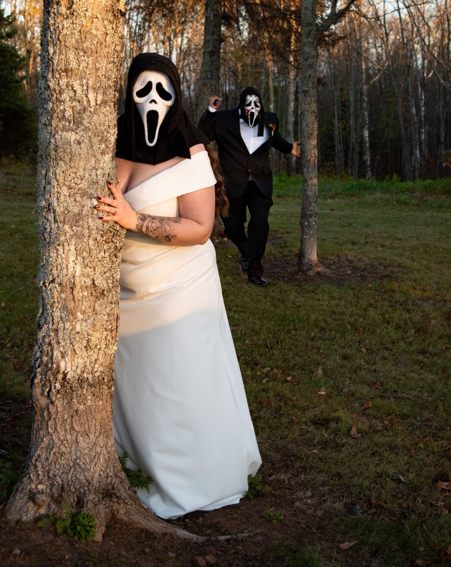 Bride and groom wearing Ghostface Scream masks during Halloween-themed outdoor wedding.