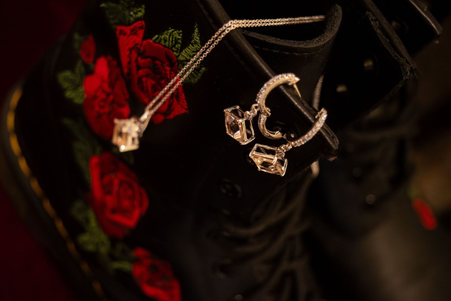 Black floral embroidered boots with diamond crystal jewelry accessories displayed as wedding details.