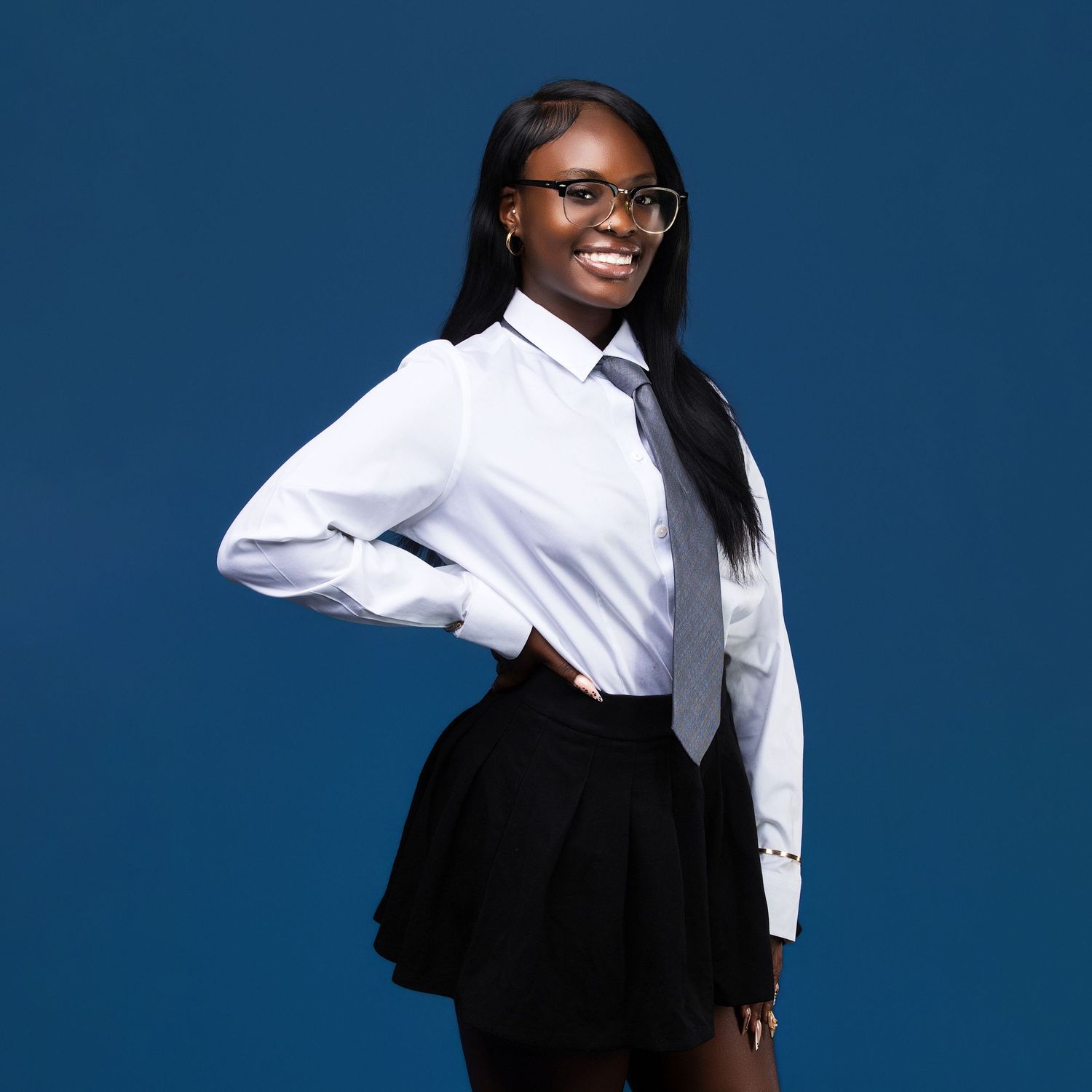 Dynamic portrait series in black and white business attire against blue background.