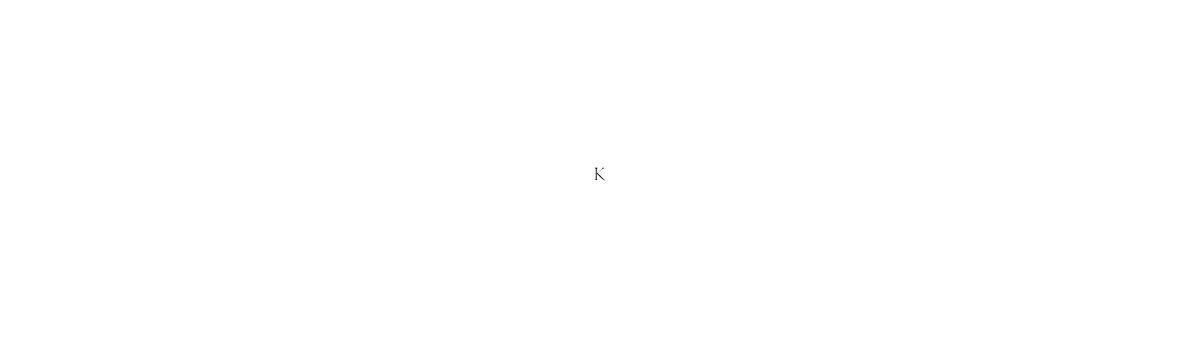 A minimalist white background image with a small centered dot or period mark.