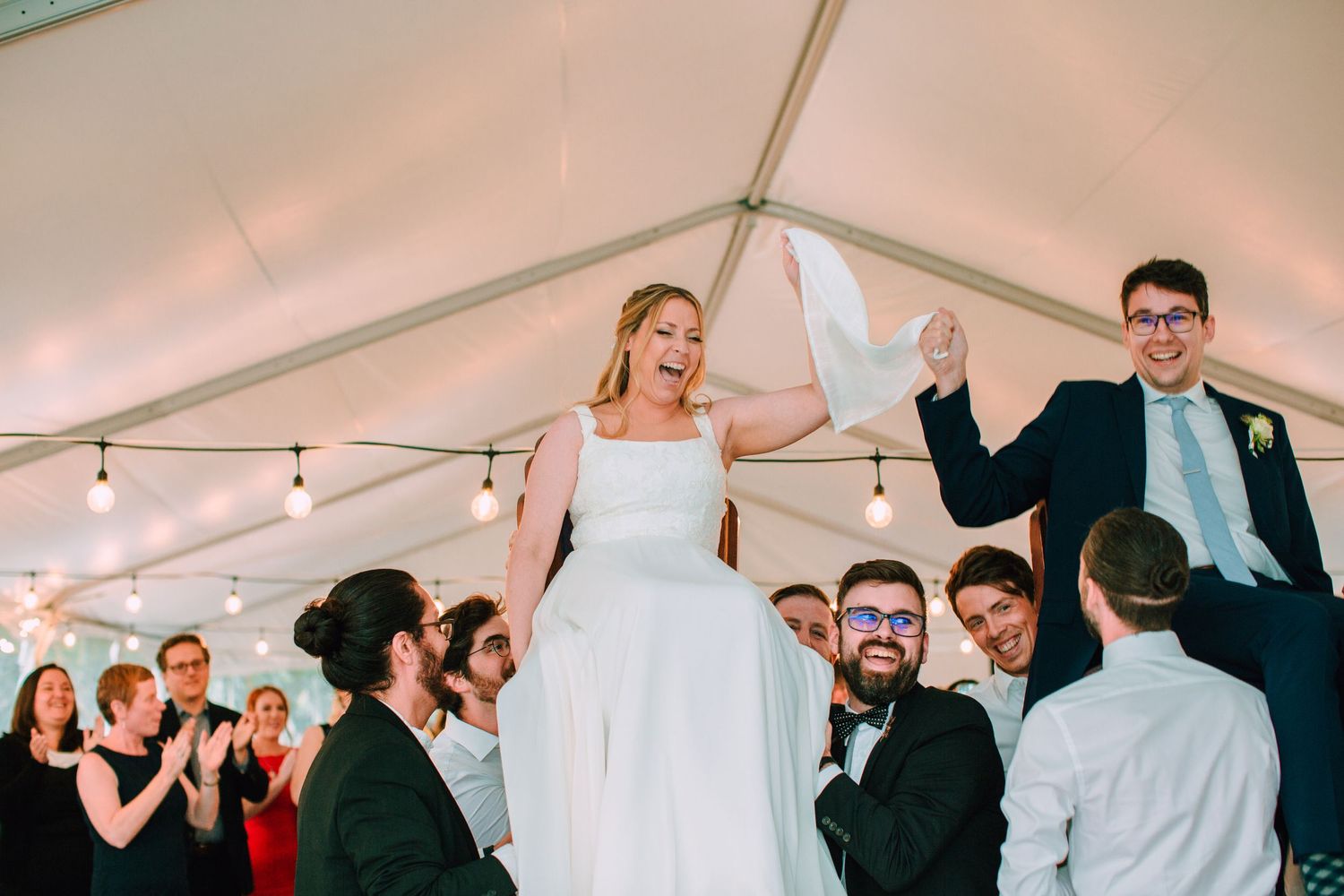 Wedding couple celebrating their marriage with the hora dance.