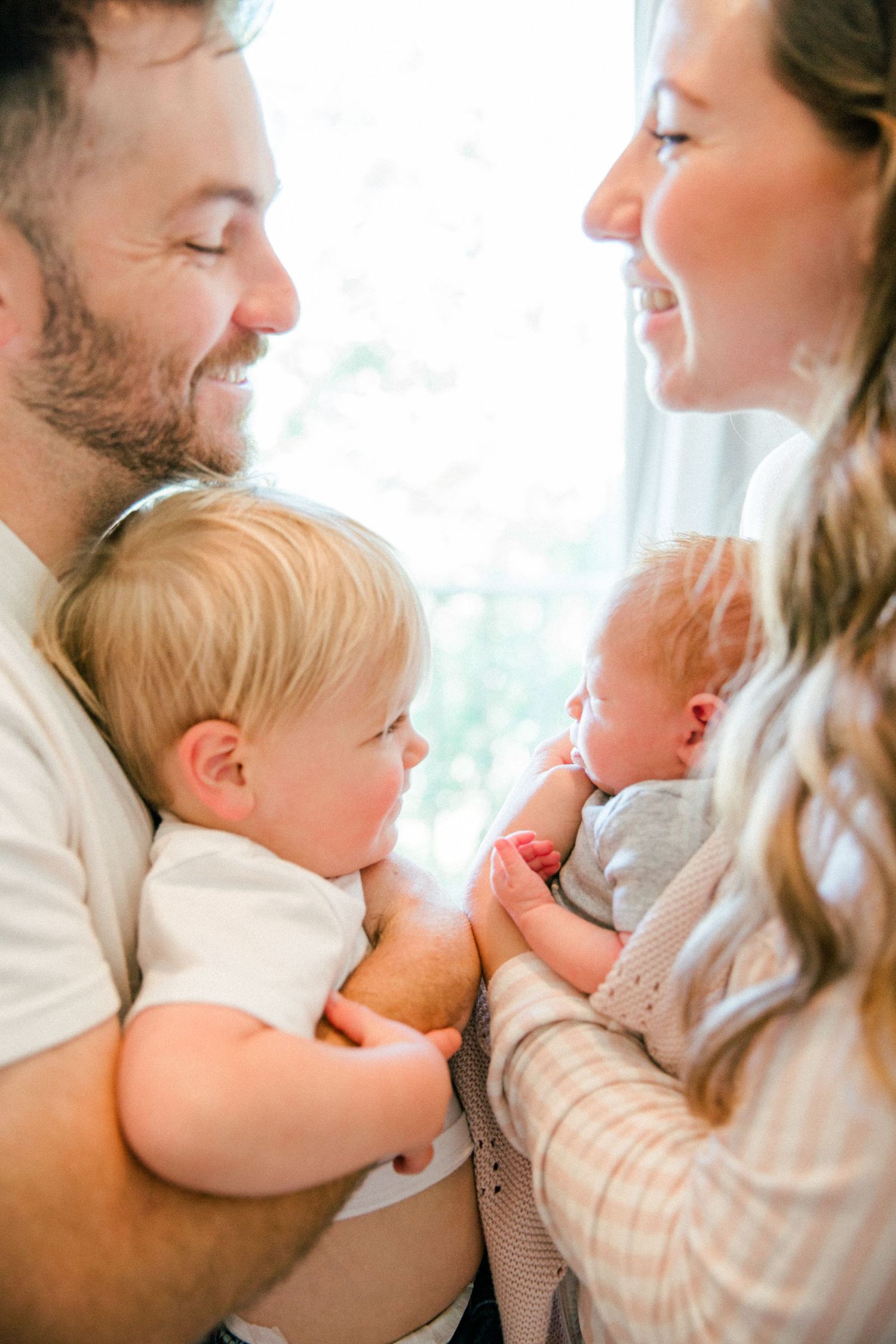 A series of candid family moments showing a baby and parents sharing loving interactions in a bright, sunlit room.