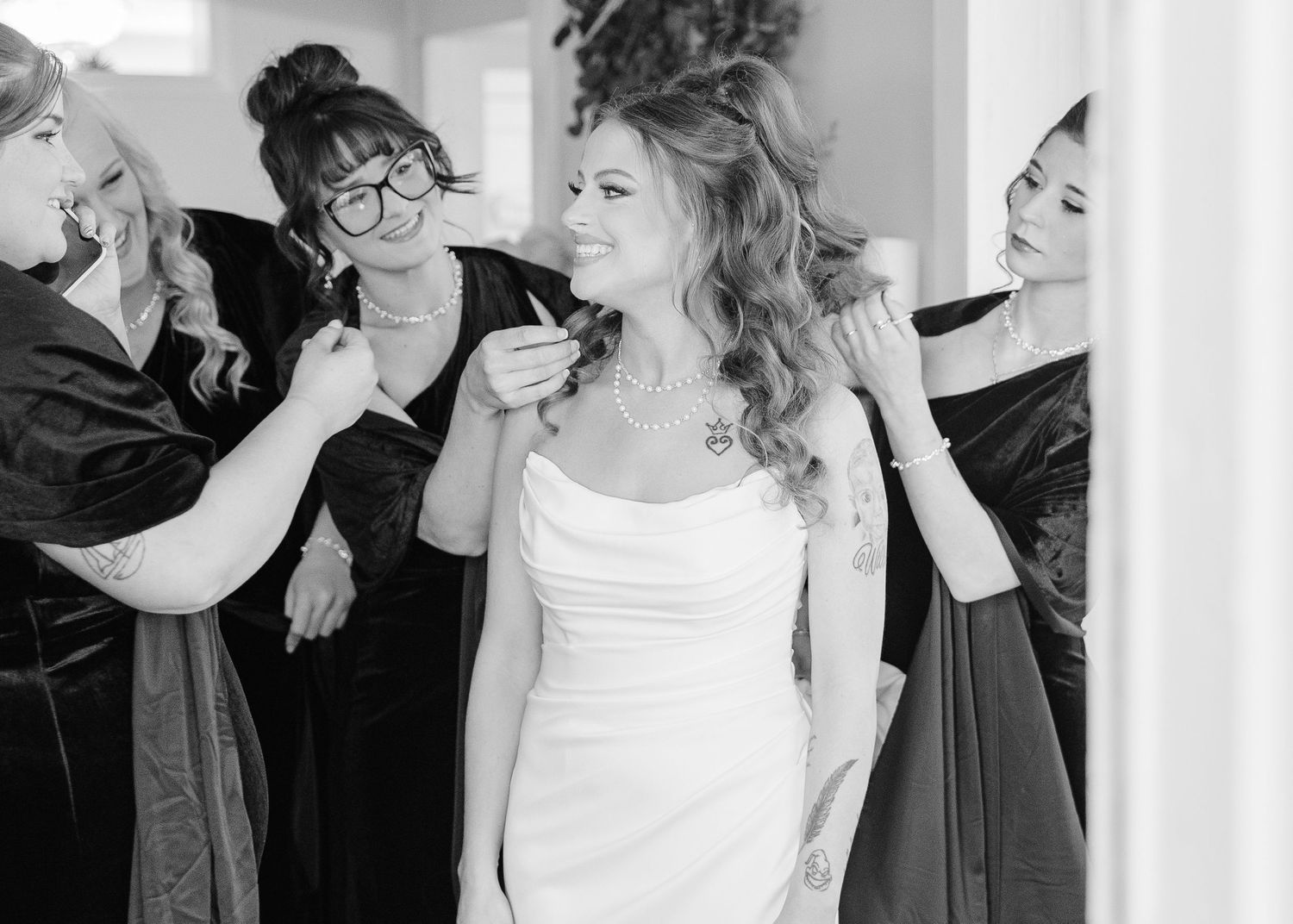 Black and white photo of wedding preparation with styling team at work.
