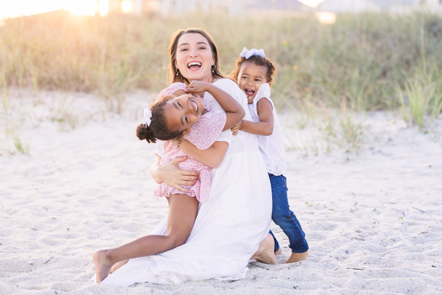 Joyful expressions during a casual family beach photography session.