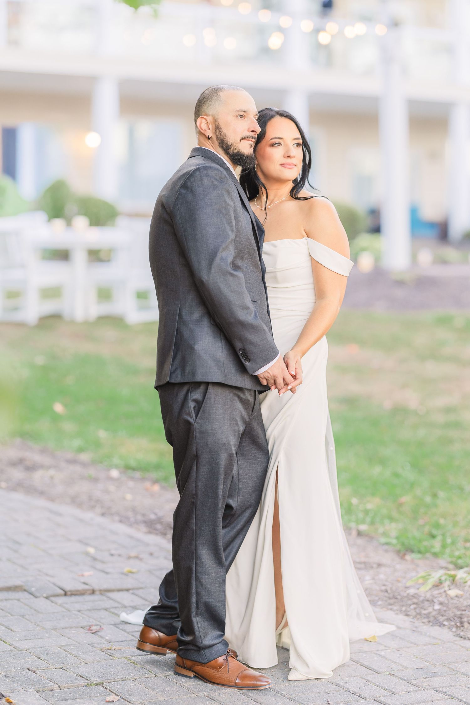 Newlywed couple shares intimate moments on a stone pathway during their wedding photoshoot wedding groom bride lake Gaston photographer ligh