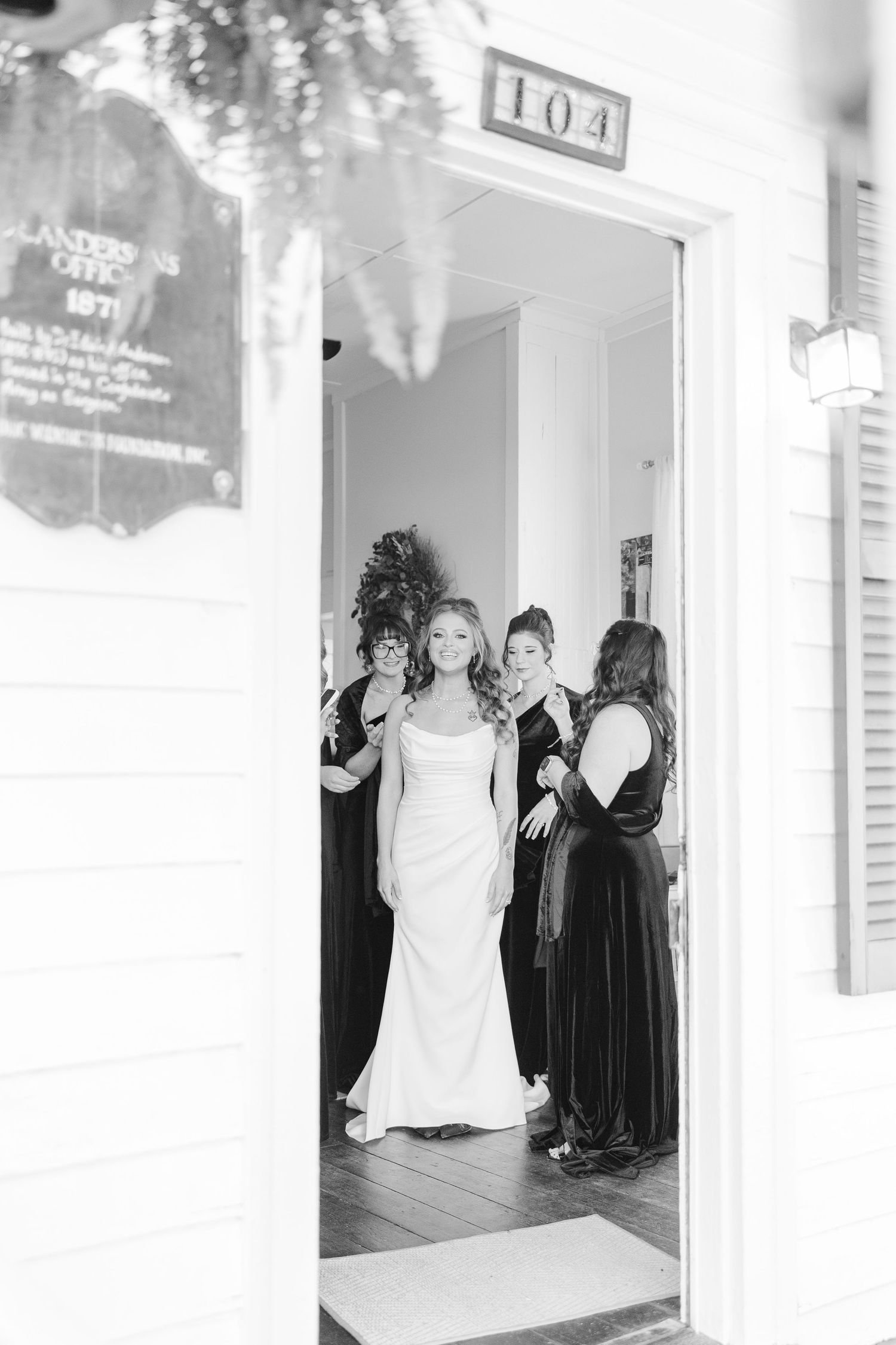 Black and white photo showing wedding preparations in a bridal suite.