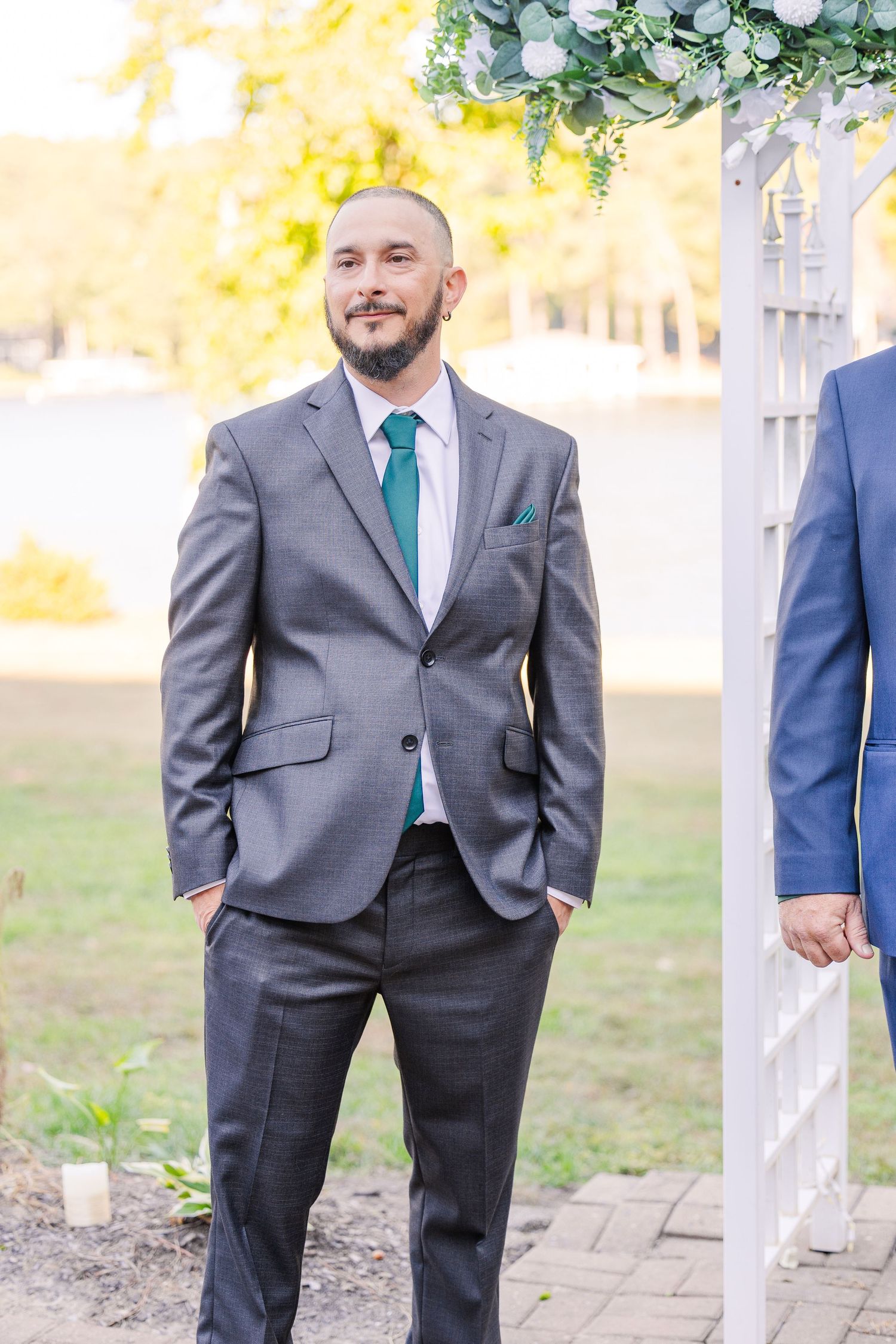 Groomsmen in grey suits with teal ties stand together at outdoor wedding wedding groom bride lake Gaston photographer light airy