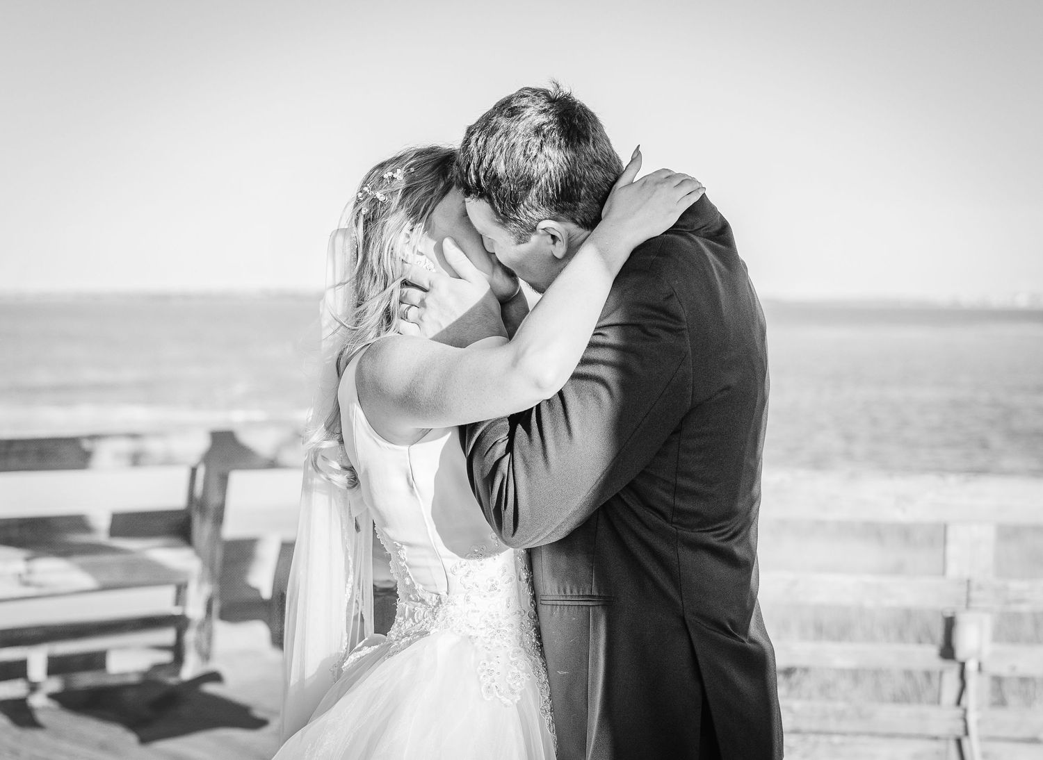 Romantic black and white wedding portraits on coastal boardwalk at sunset southport elopement wedding bride groom light and airy classic