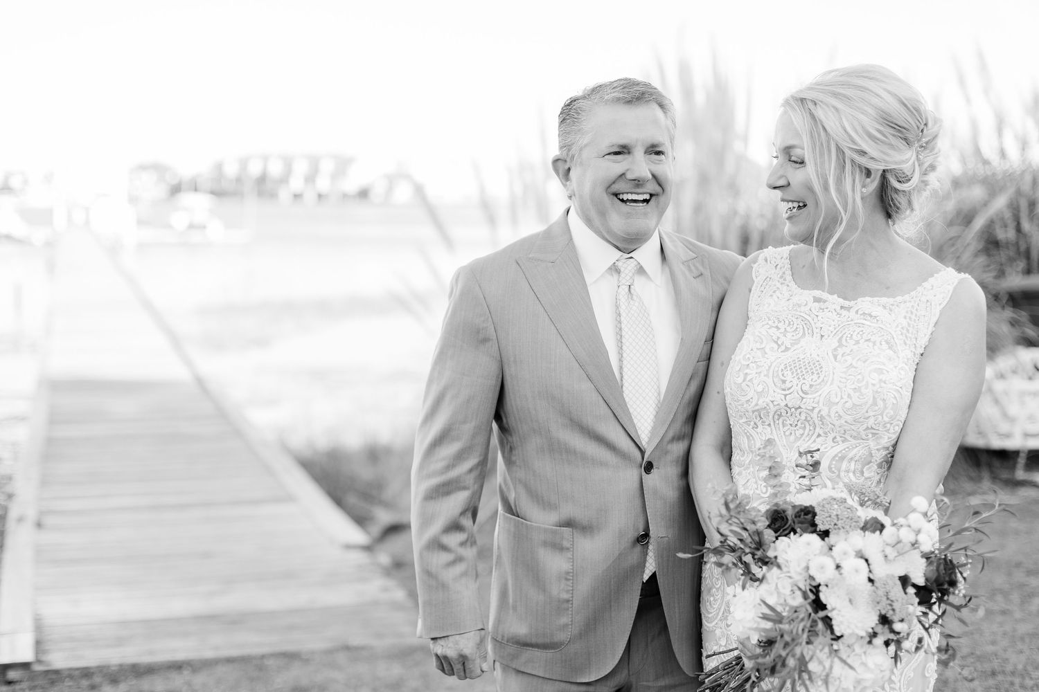 Romantic black and white wedding portraits showing joyful moments between couple.