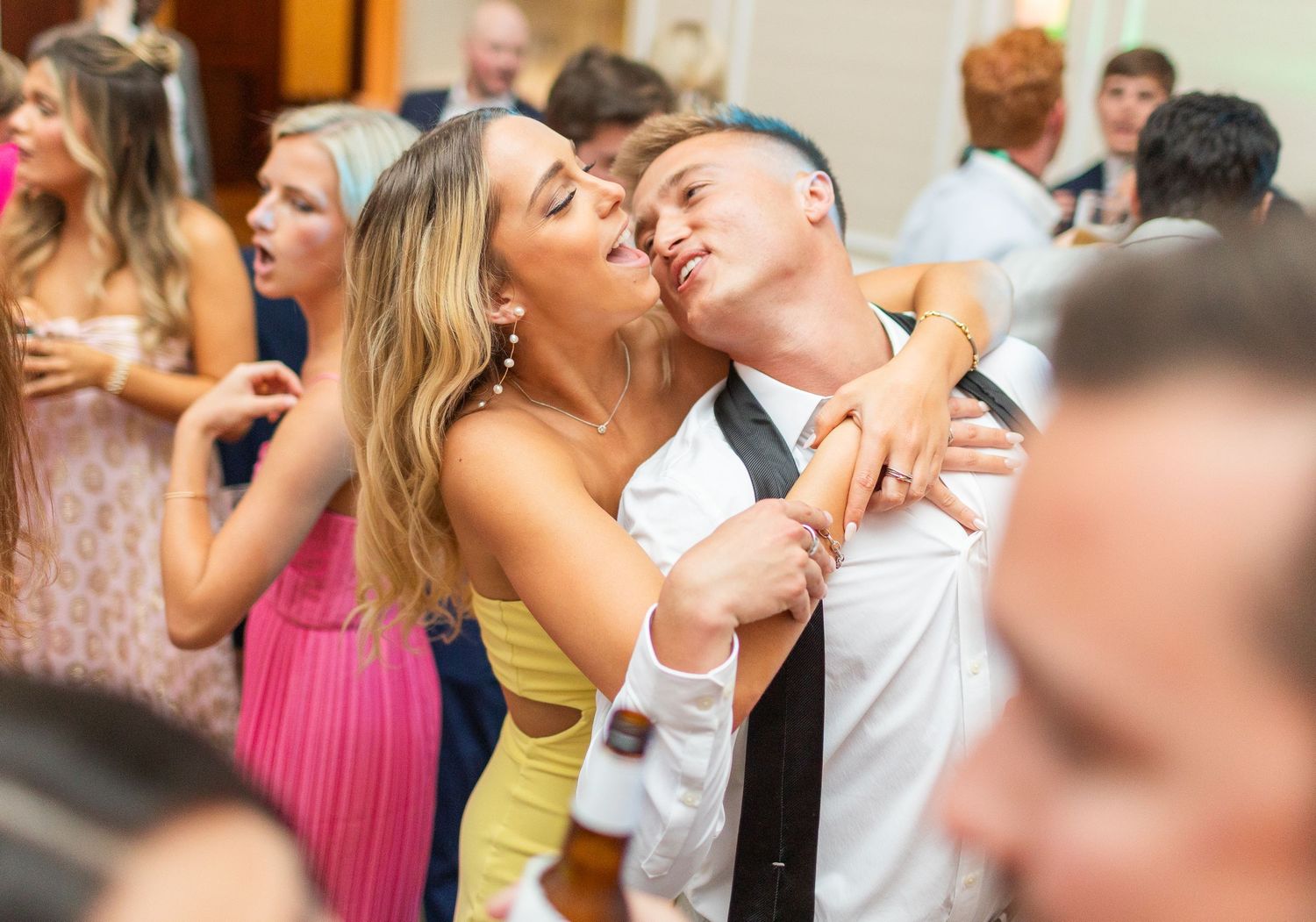Wedding guests dancing and celebrating  landfall wedding bride groom light and airy classic wilmington Wrightsville Beach