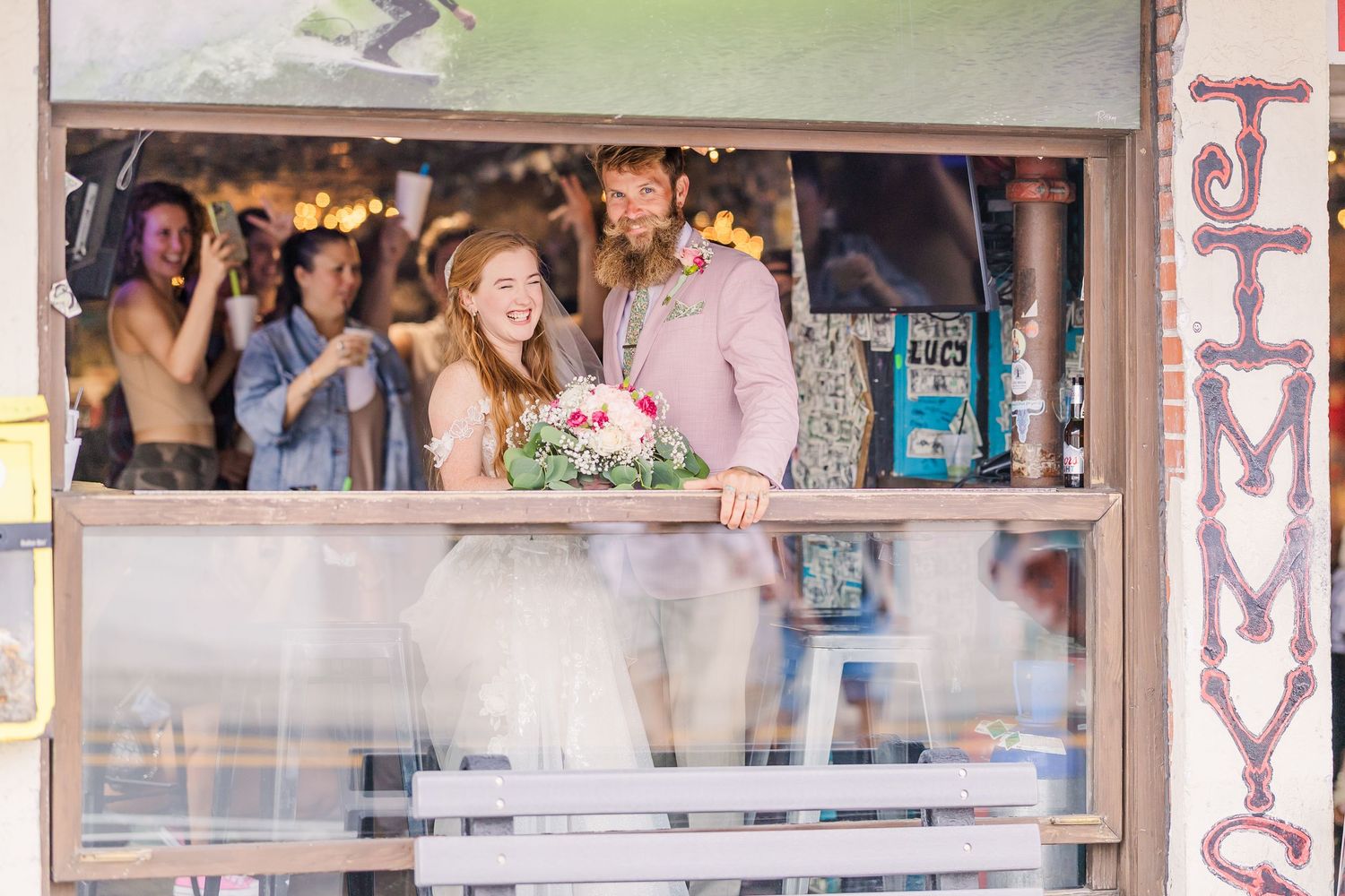 Wrightsville Beach bride and groom in jimmys dive bar embracing in a sweet moment after their wedding in wilmington, nc