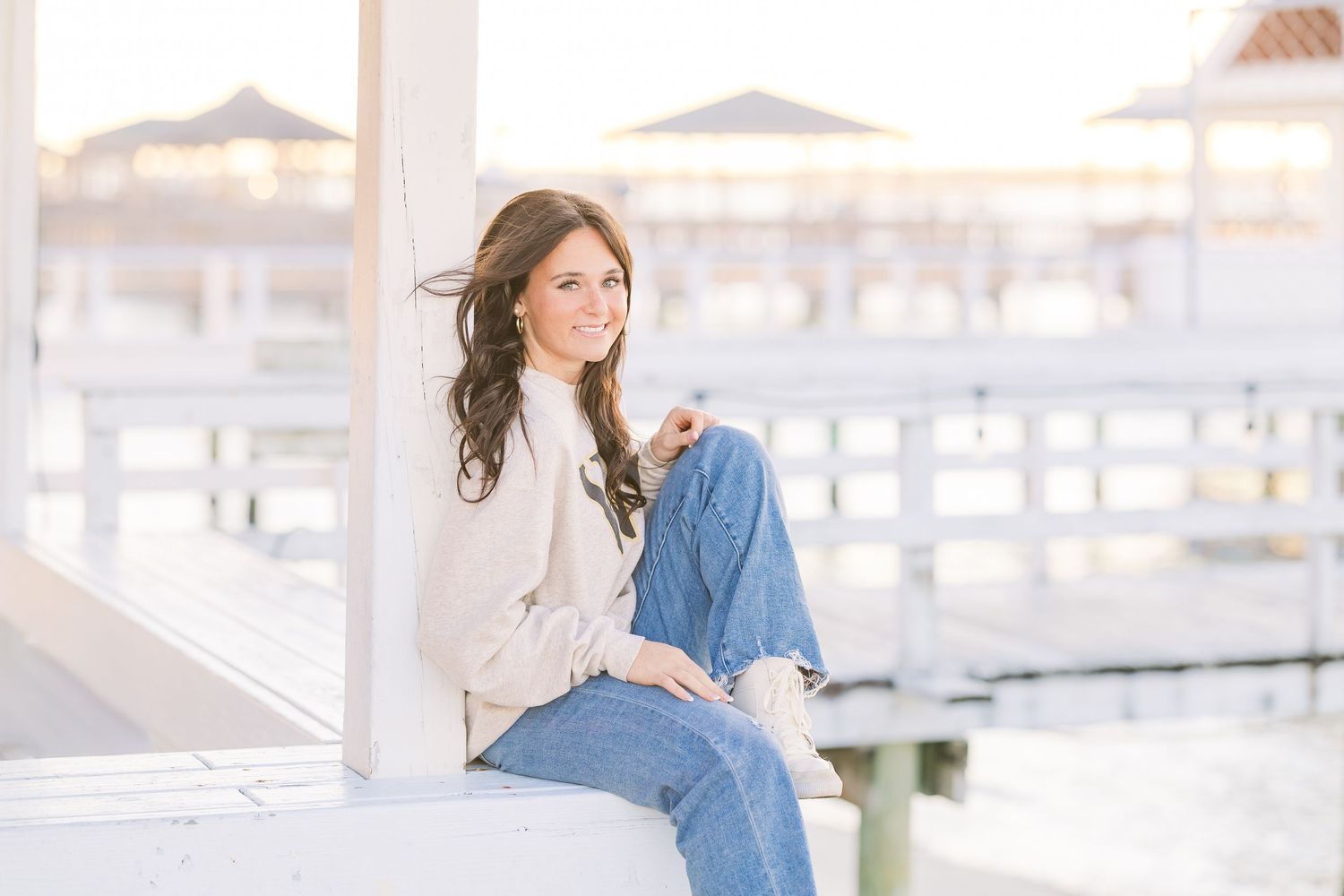 Casual lifestyle scene at coastal dock with weathered wood and marina views.